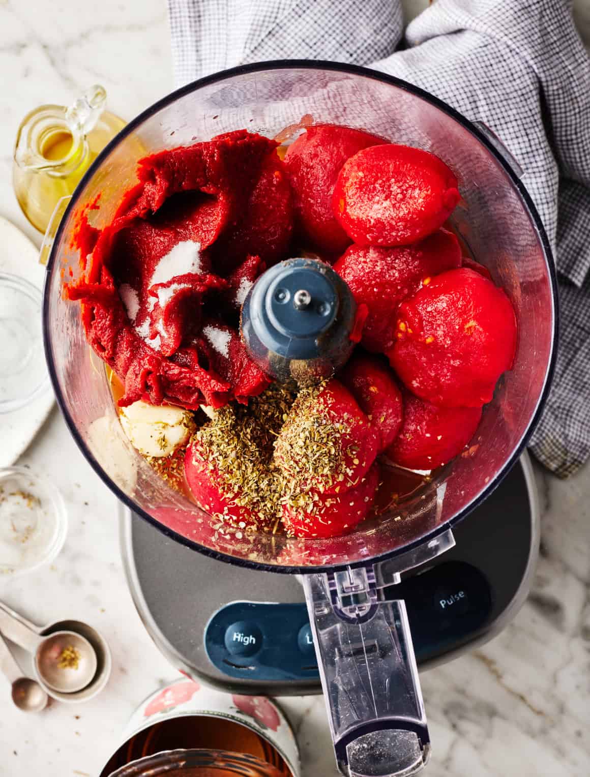Whole peeled tomatoes, tomato paste, olive oil, garlic, dried herbs, and sea salt in a food processor
