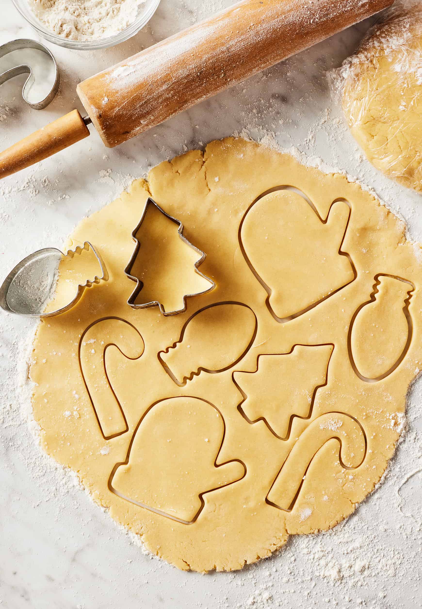 Cutting out Christmas sugar cookies from rolled-out dough