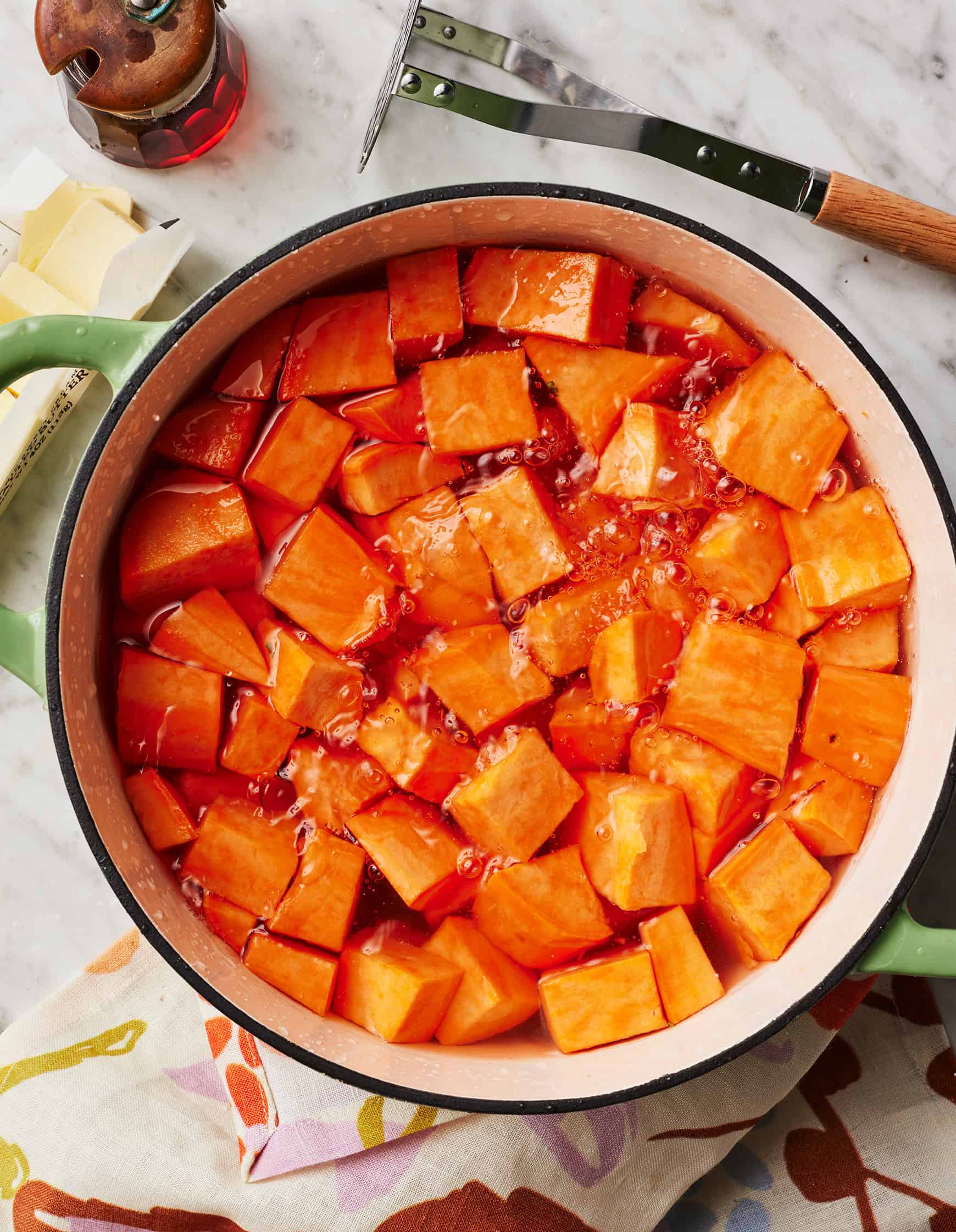 Boiling sweet potato cubes in large pot