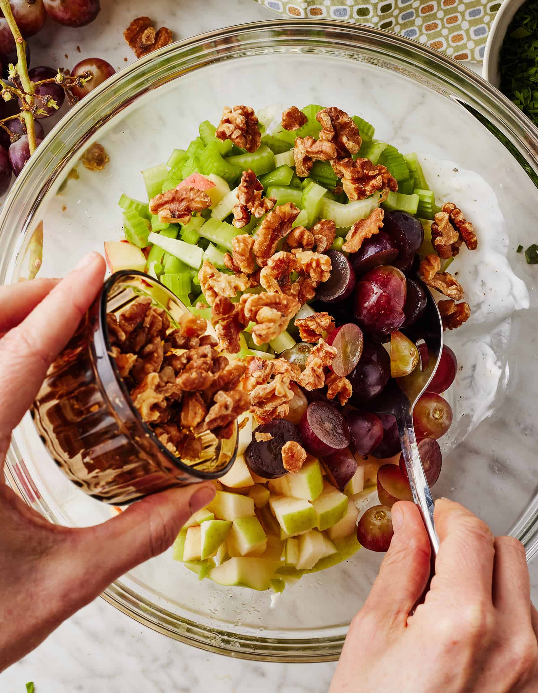 Adding walnuts to Waldorf salad