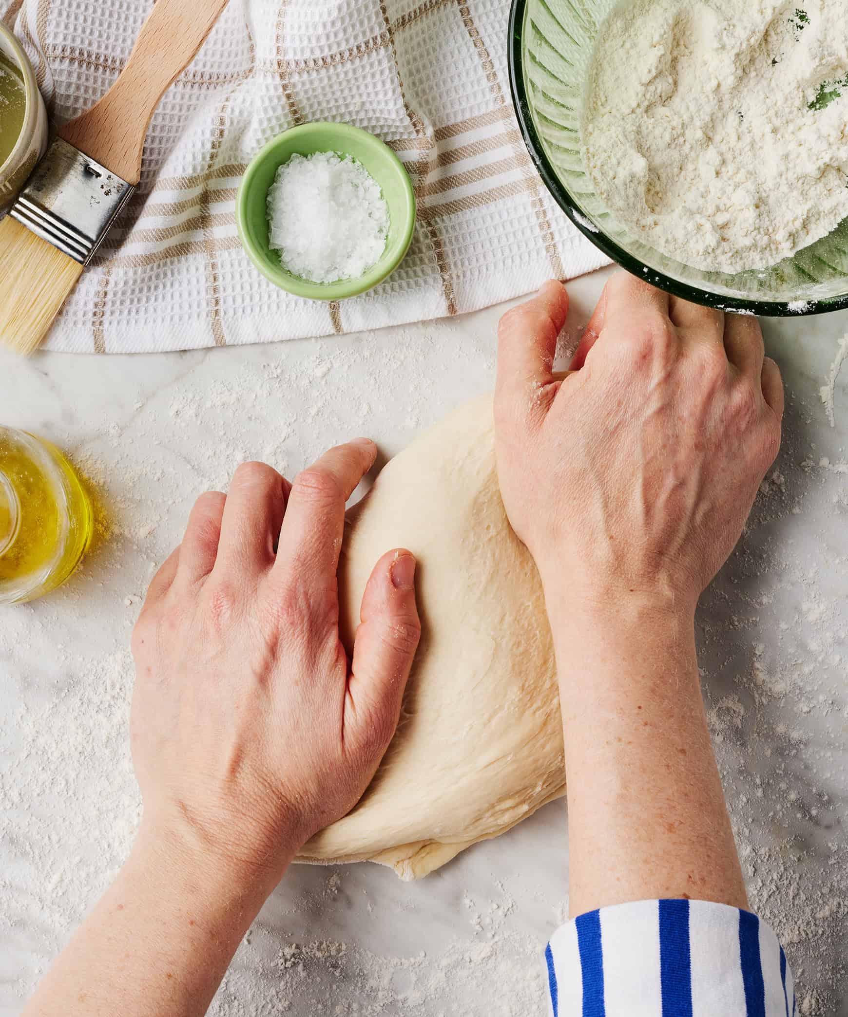 Kneading dough ball on floured surface