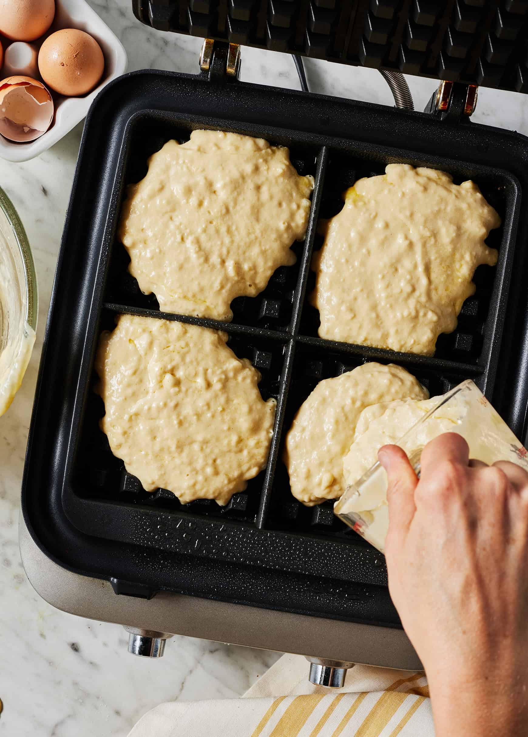 Pouring batter into waffle iron