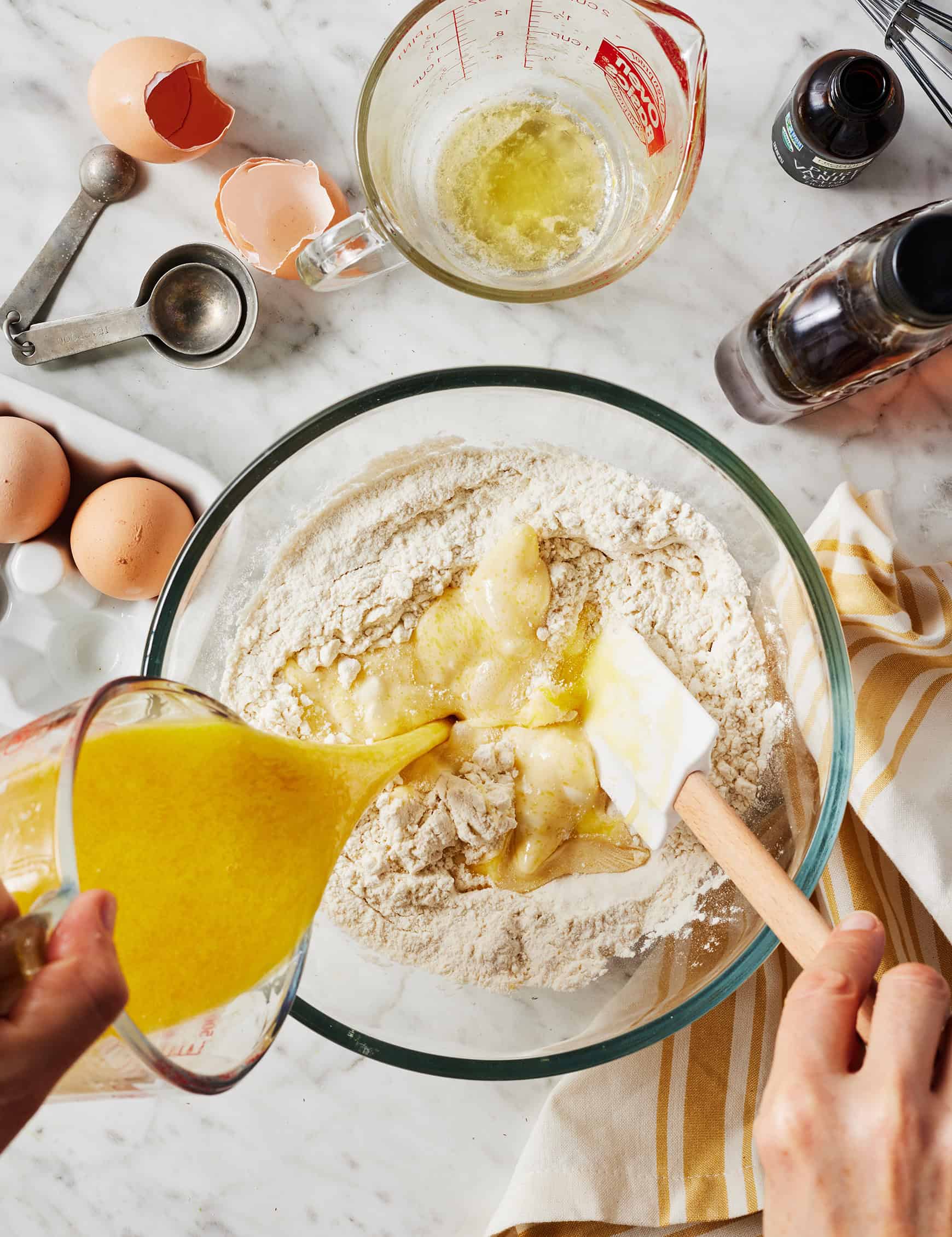 Pouring wet ingredients into dry ingredients