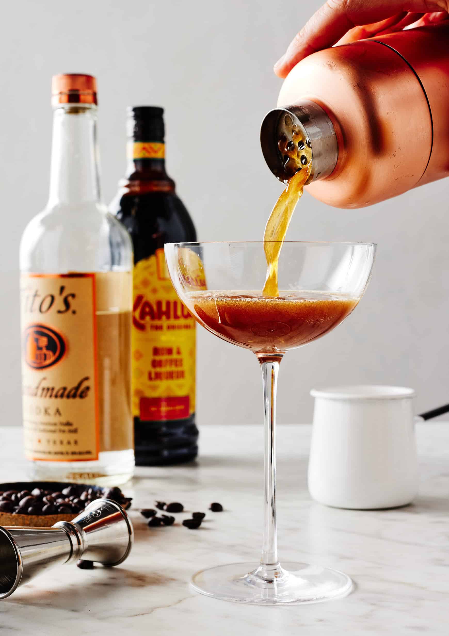 Straining cocktail into chilled glass