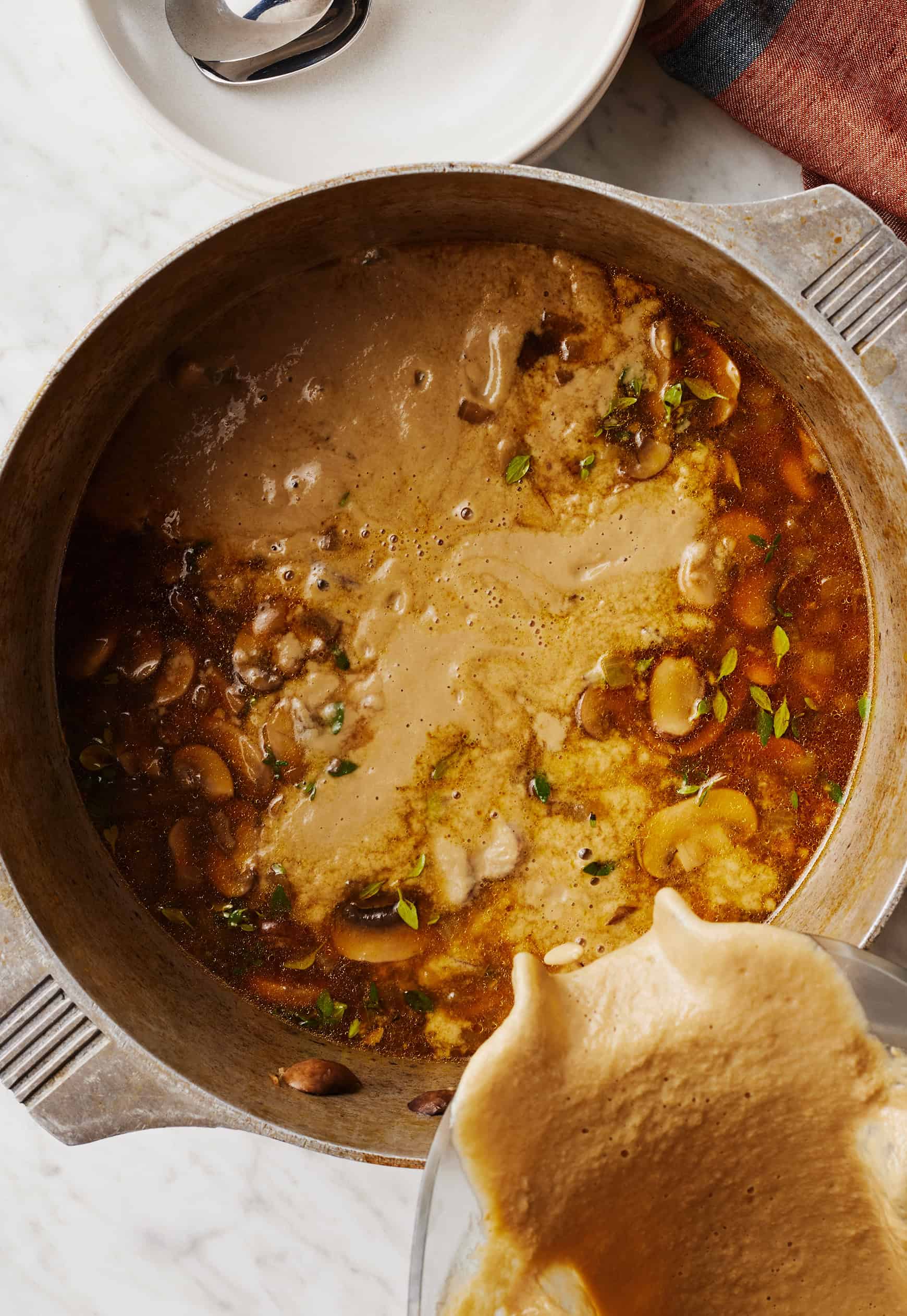 Pouring blended soup back into pot