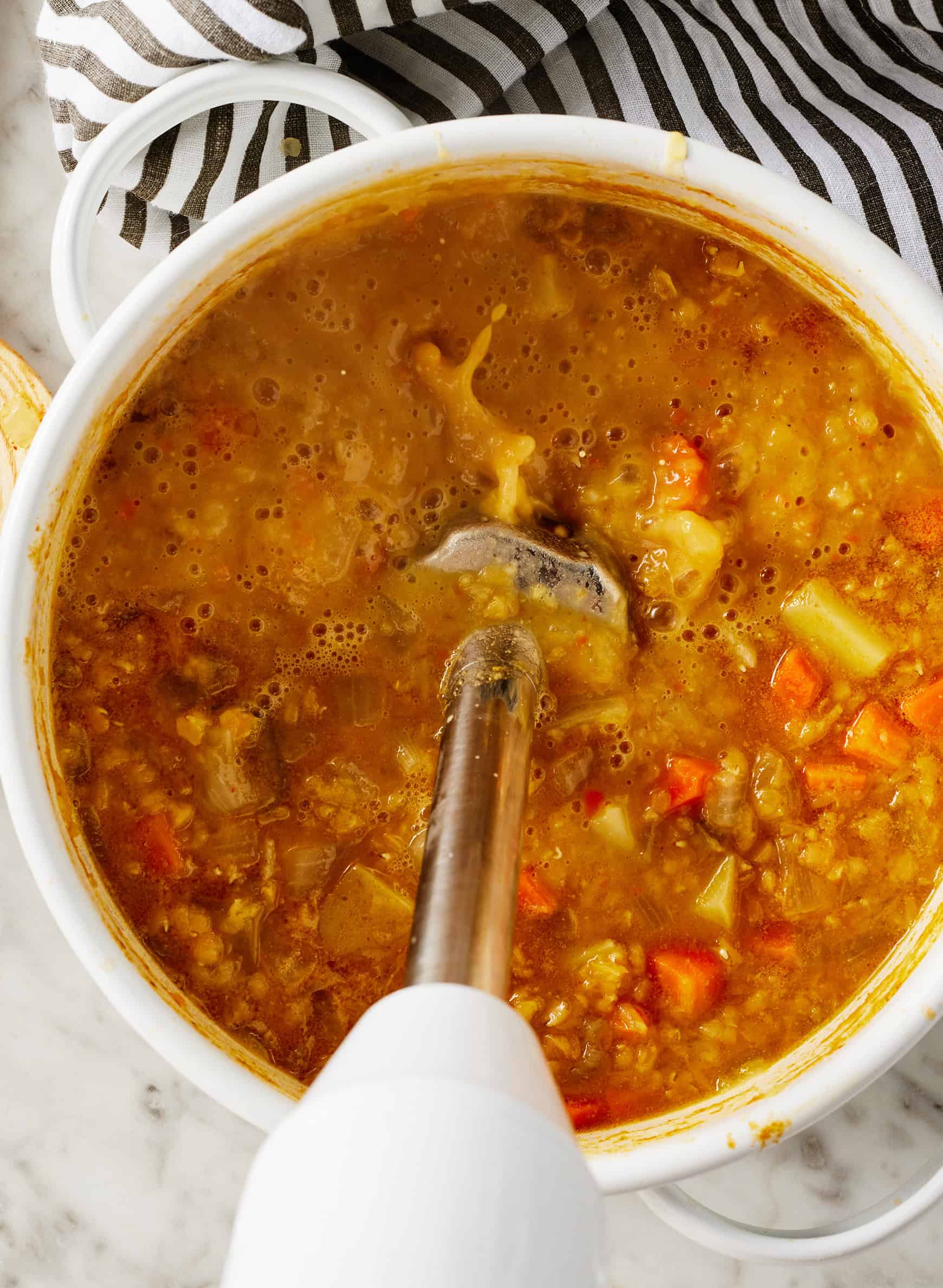 Using immersion blender to partially blend red lentil soup