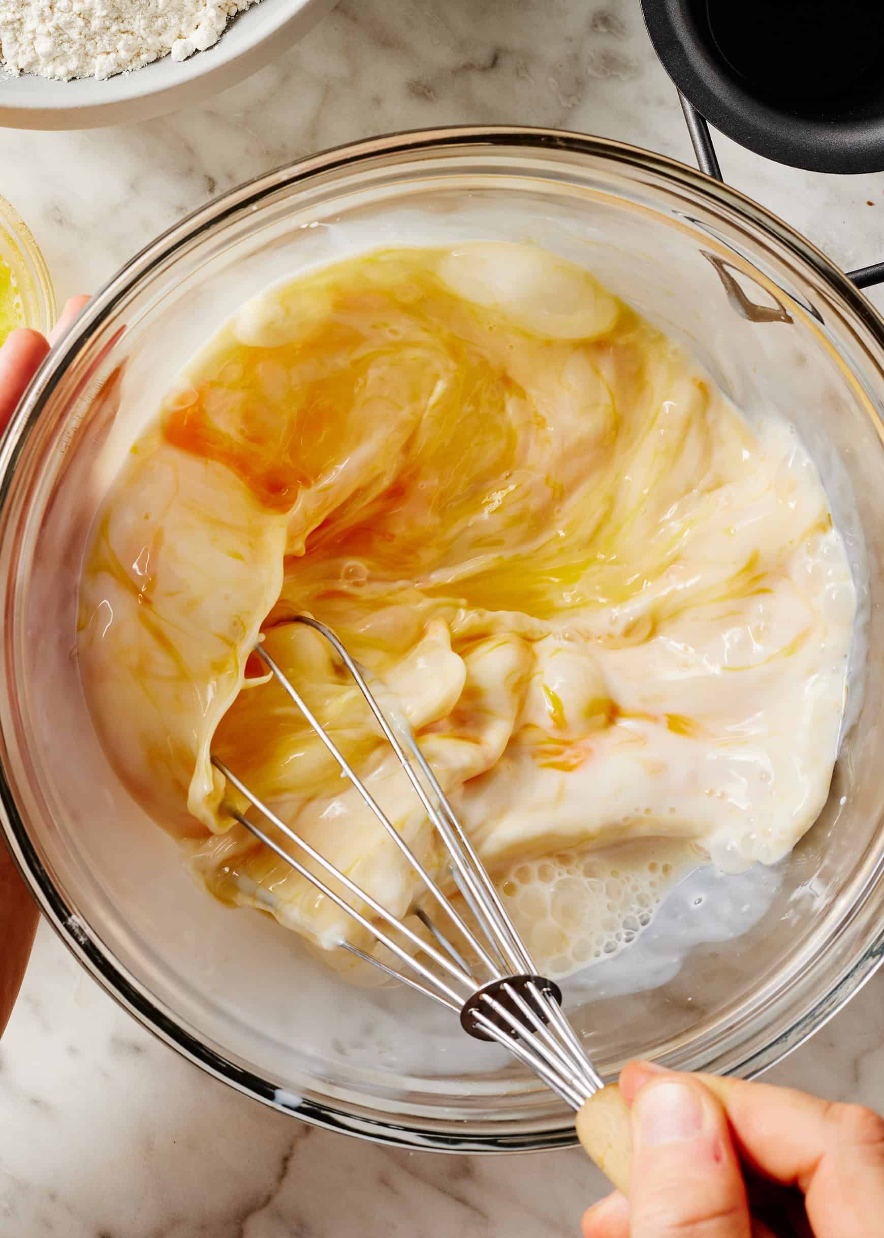 Whisking eggs and milk in glass bowl