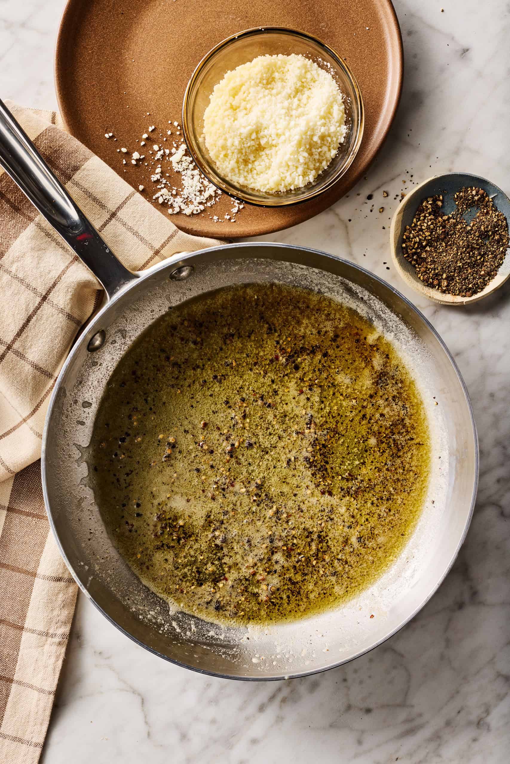 Melted butter and black pepper in skillet