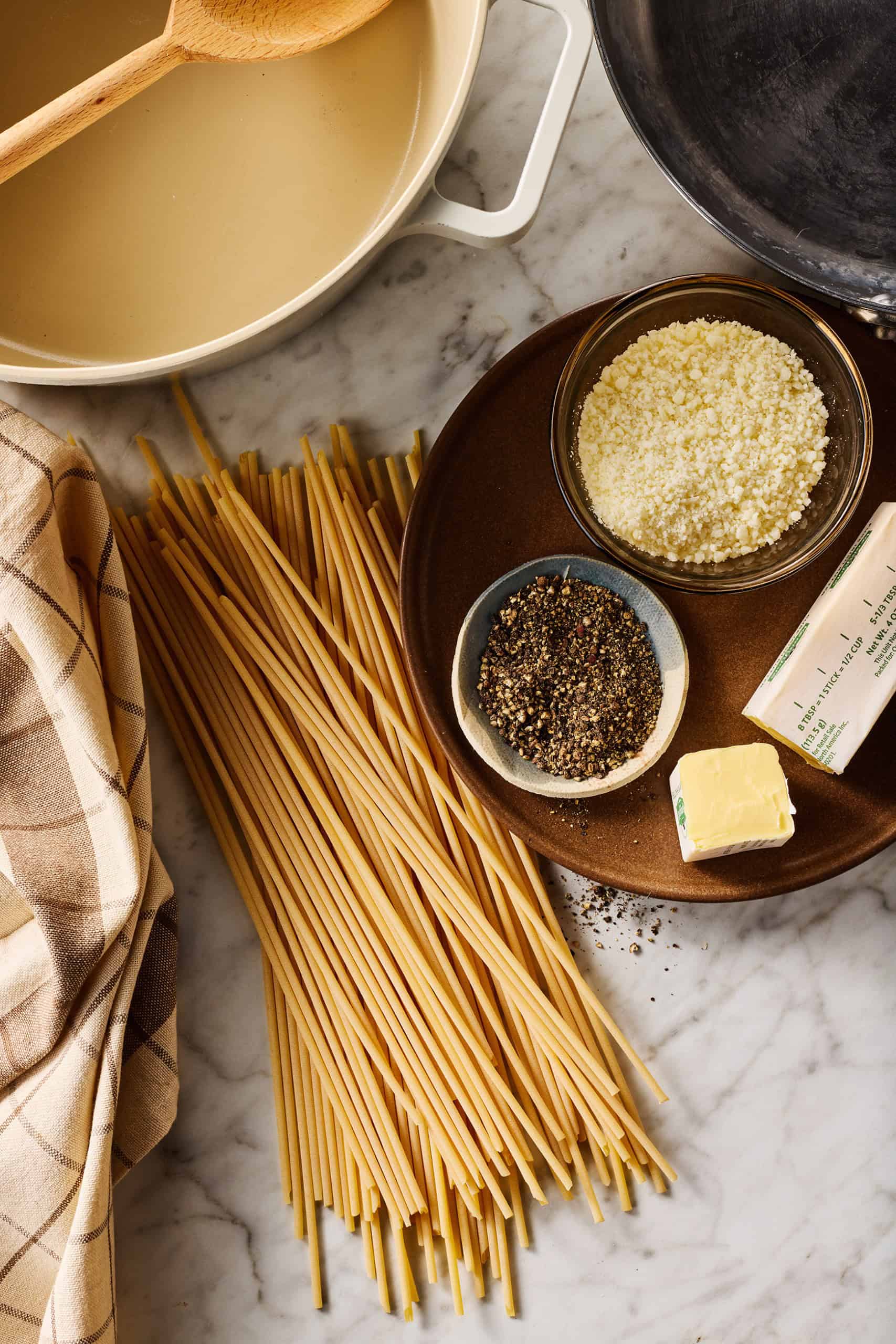 Finely gated pecorino romano cheese, black pepper, butter, and bucatini