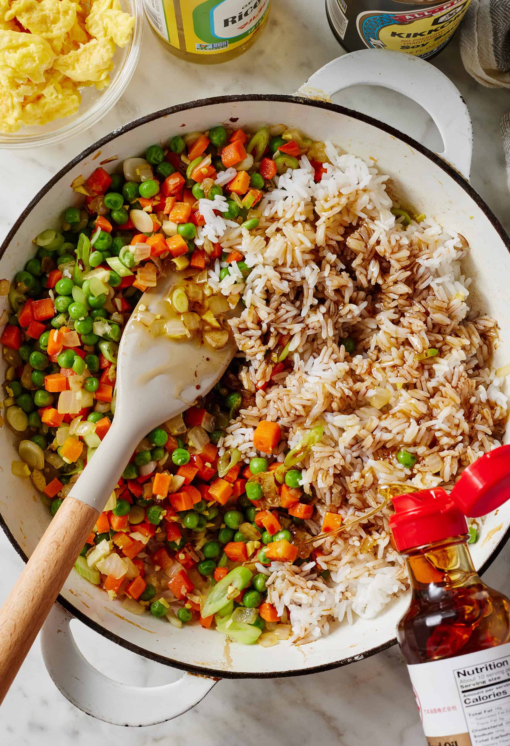 Adding sesame oil to vegetable fried rice