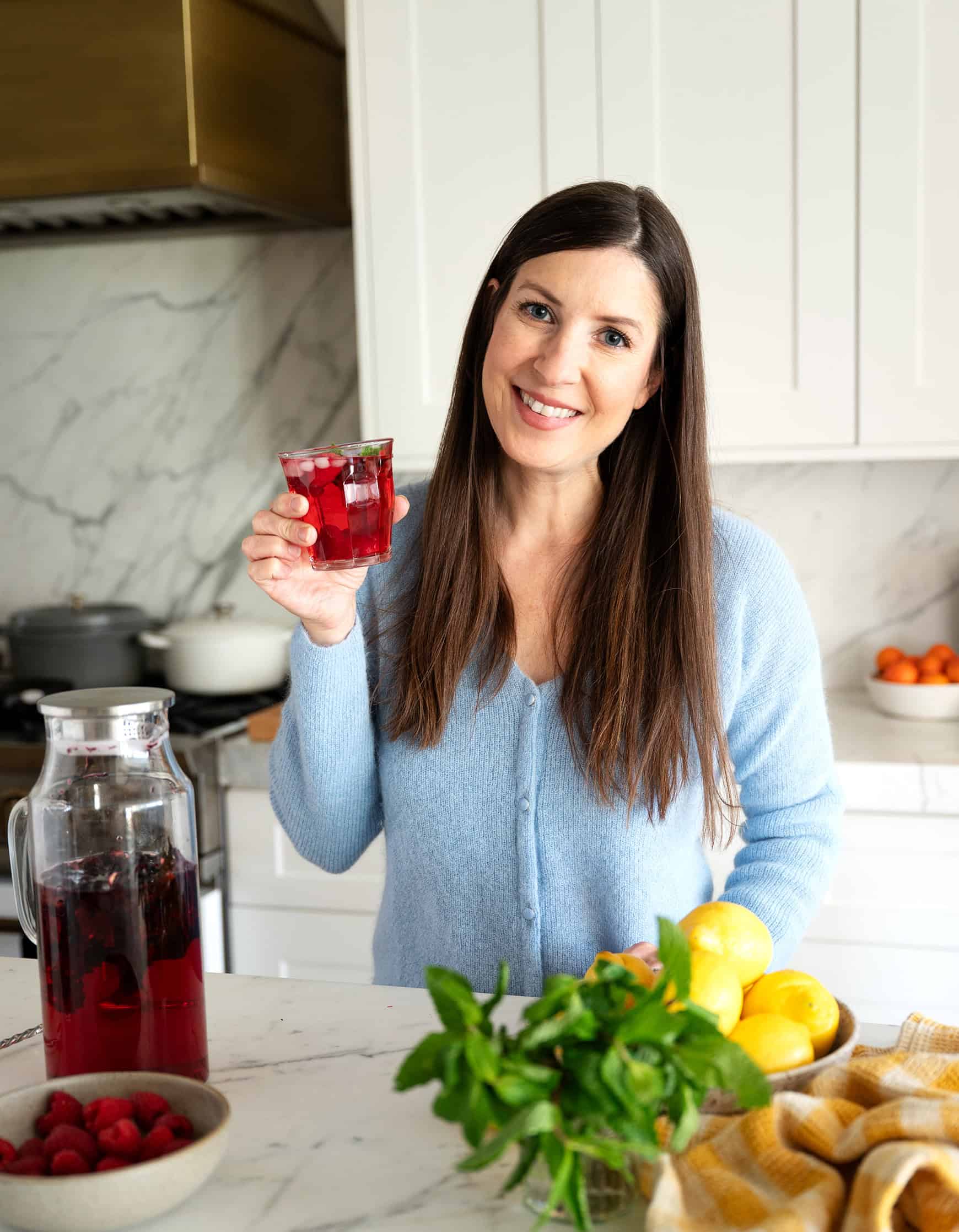 Jeanine holding glass of tea made with filtered Culligan water