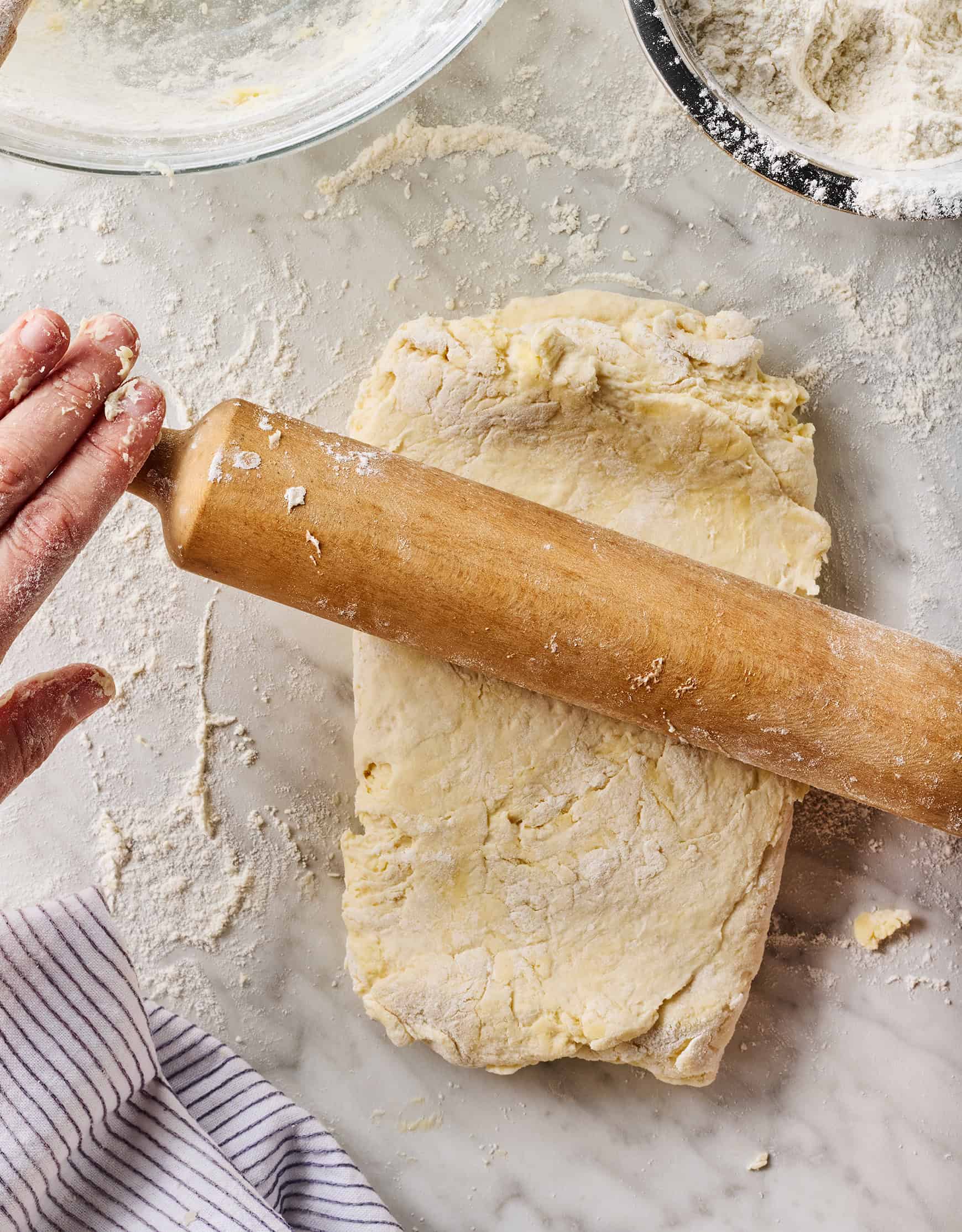 Rolling out folded dough for homemade biscuits