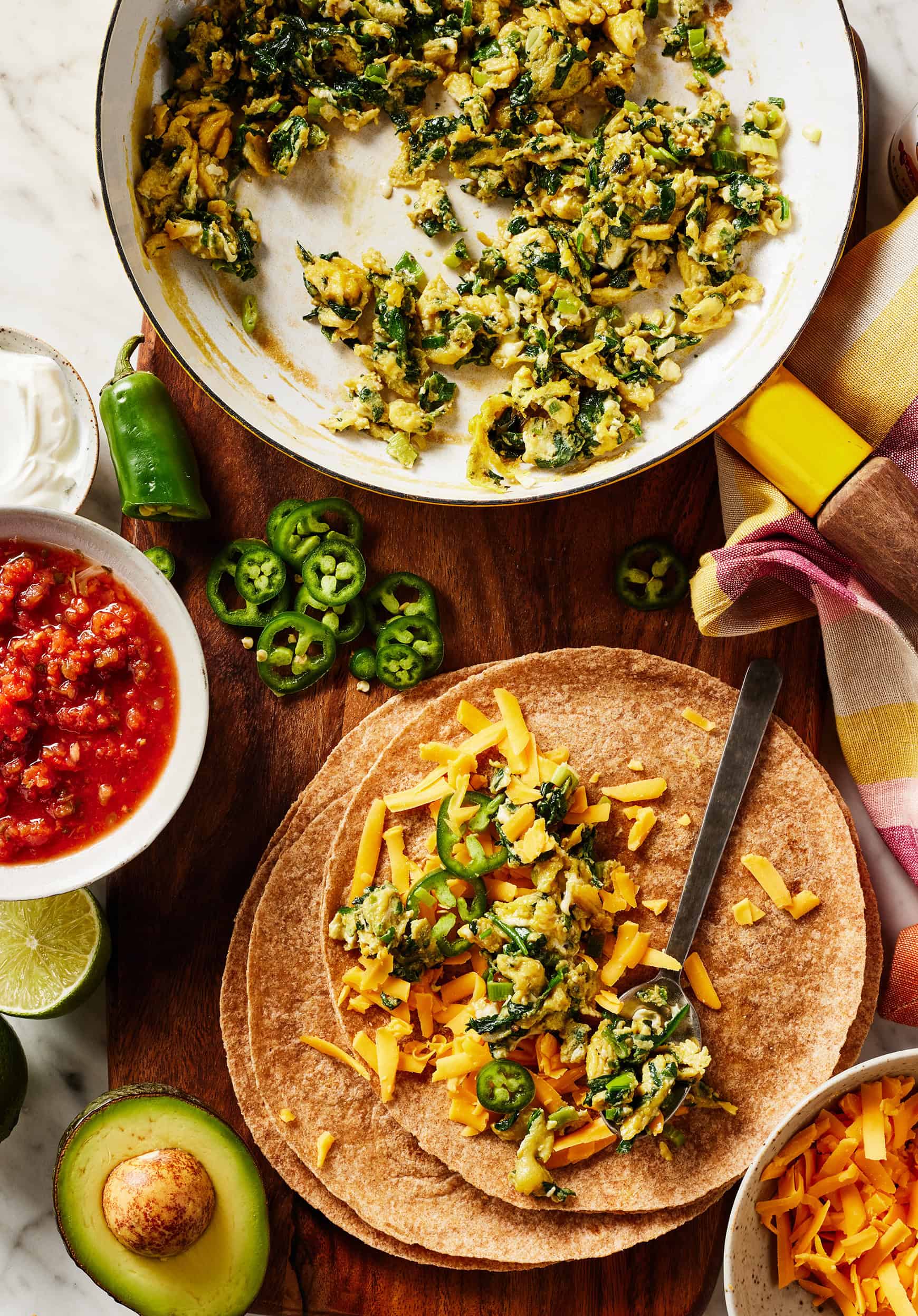 Assembling breakfast quesadilla in tortilla