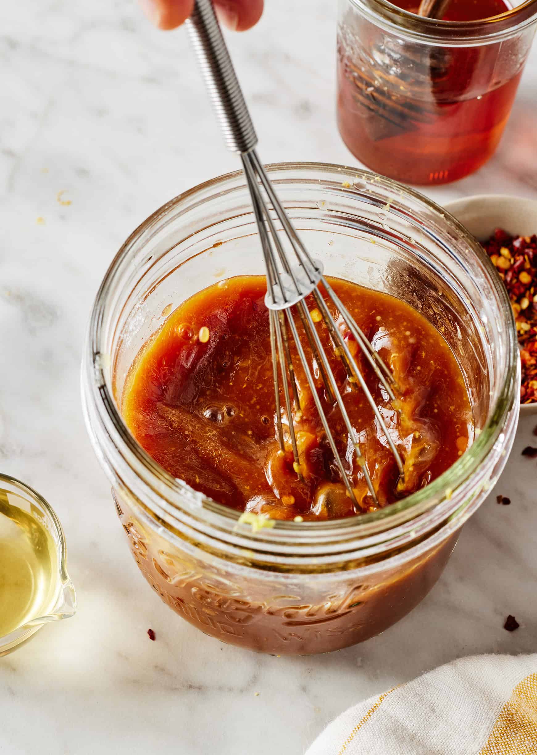 Whisking ingredients together in glass jar