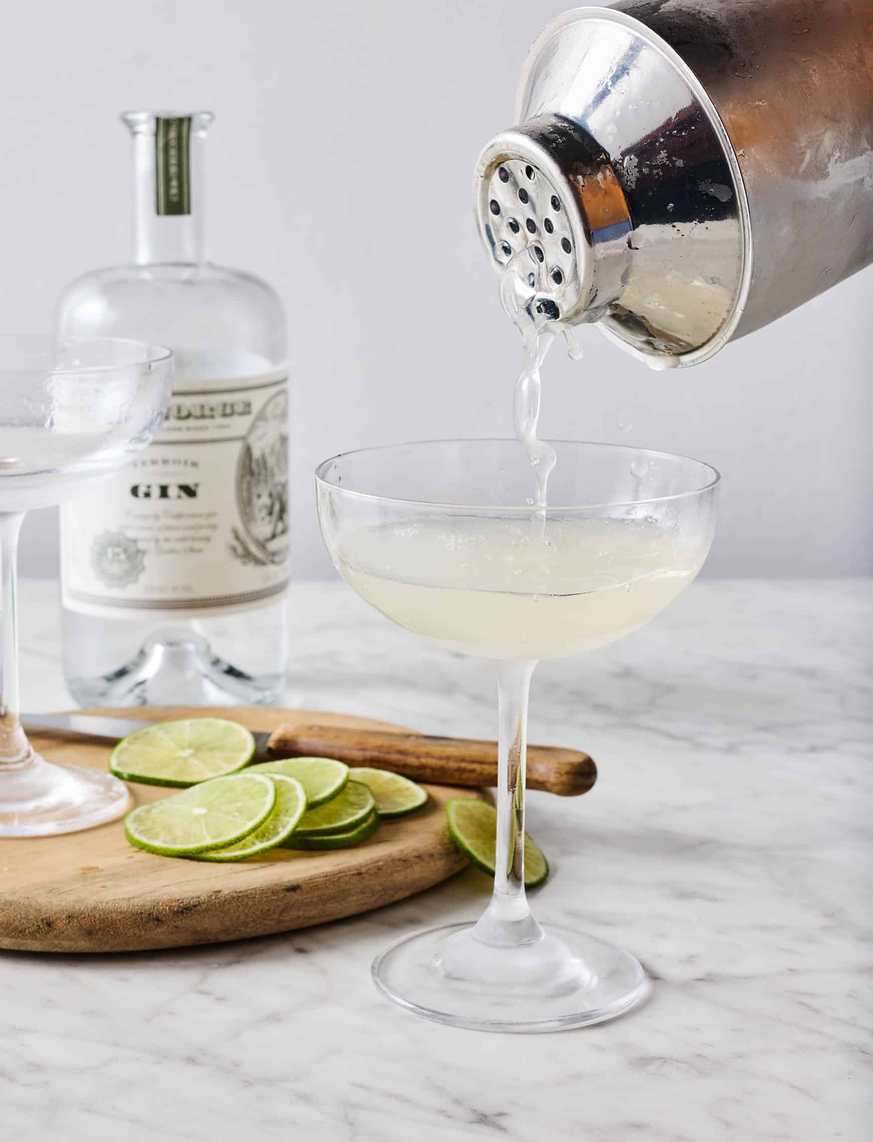 Pouring cocktail into coupe glass