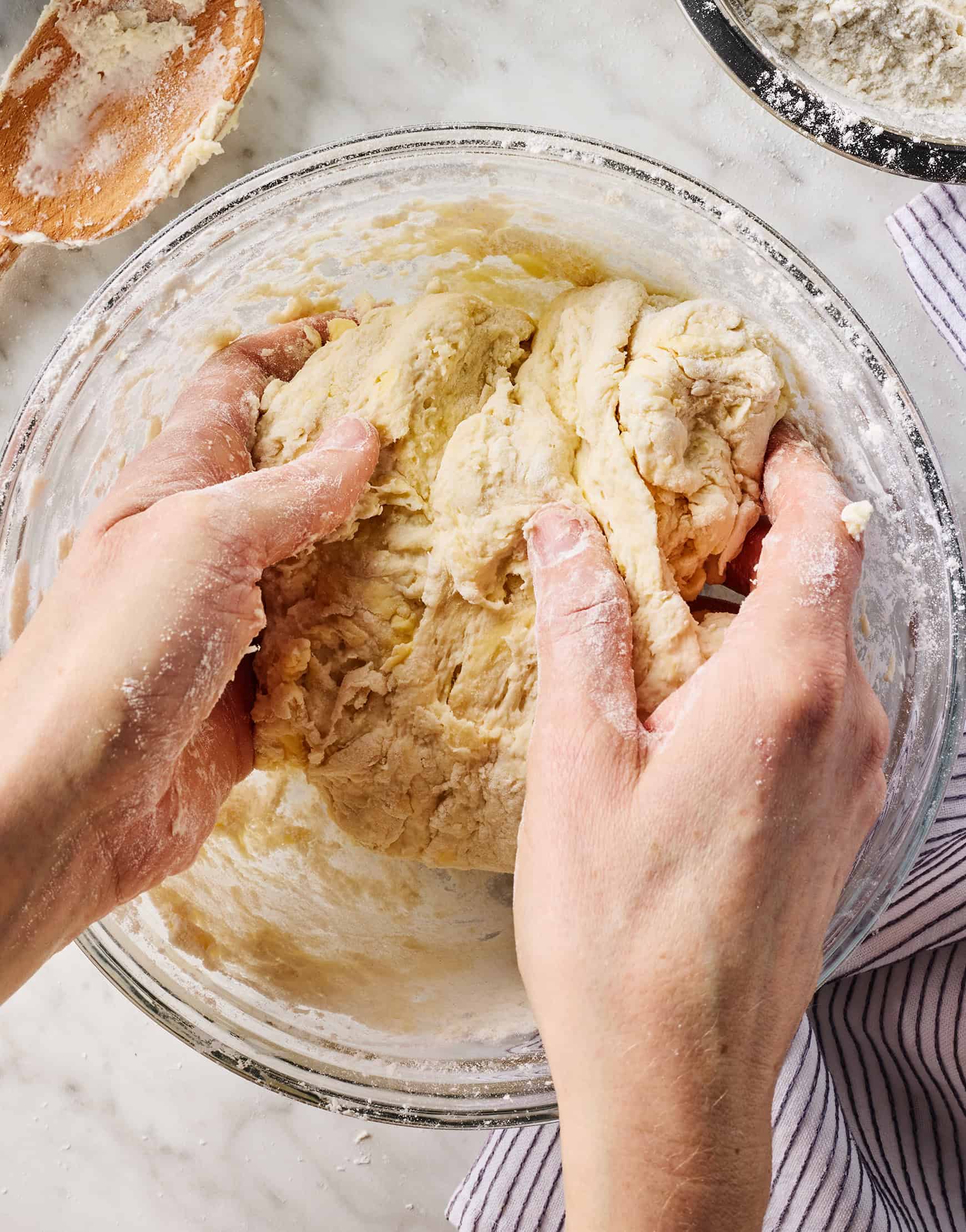 Kneading biscuit dough in bowl