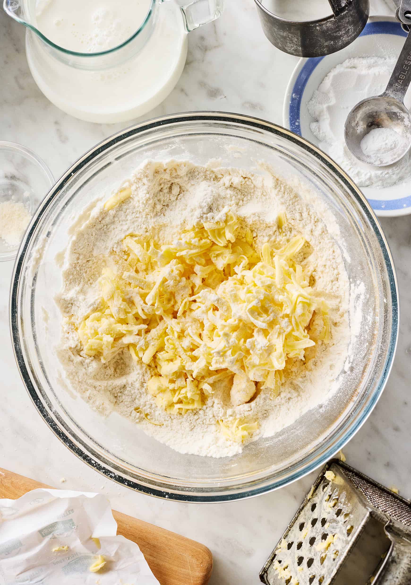 Grated butter in bowl with dry ingredients