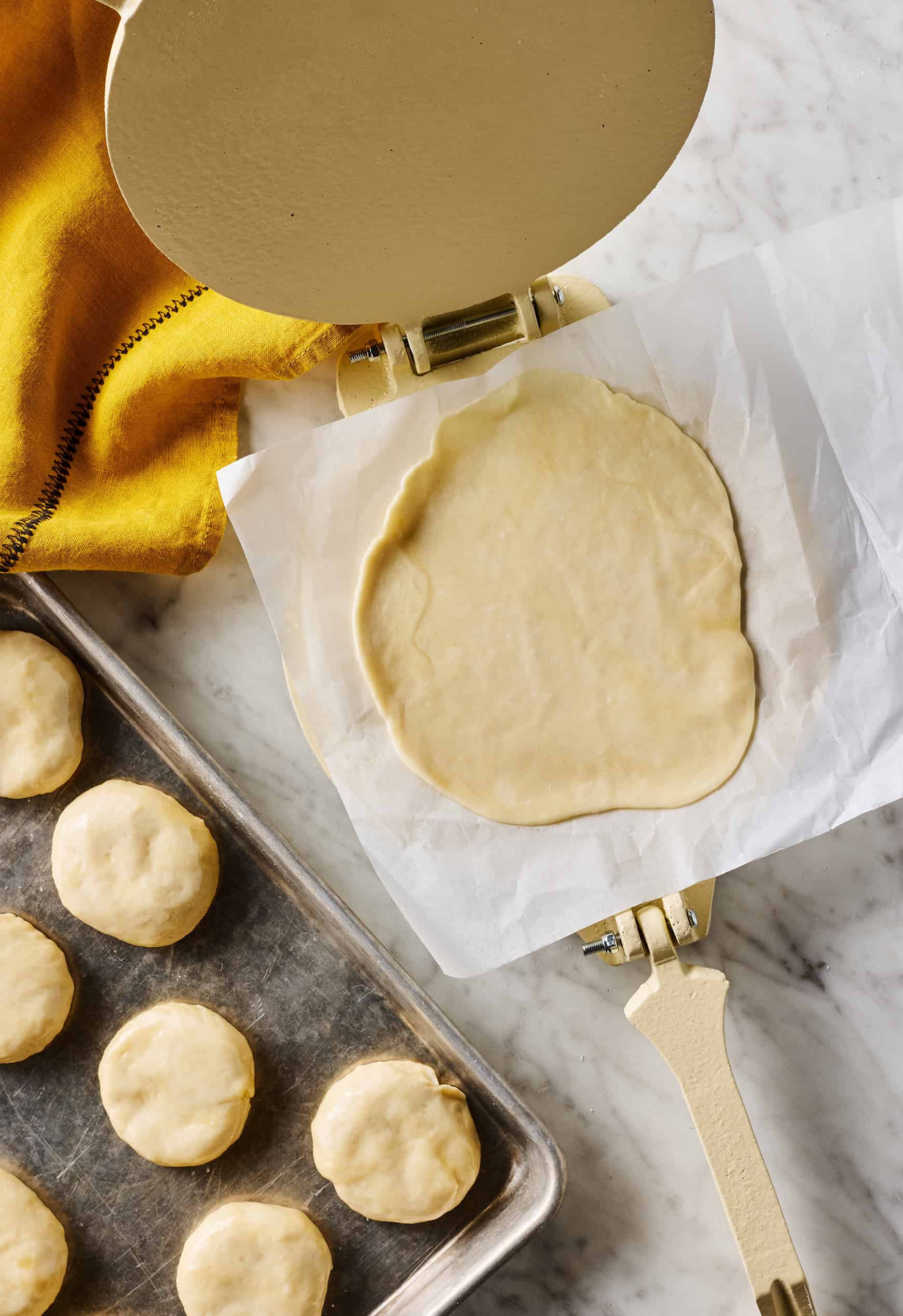 Using tortilla press to flatten dough