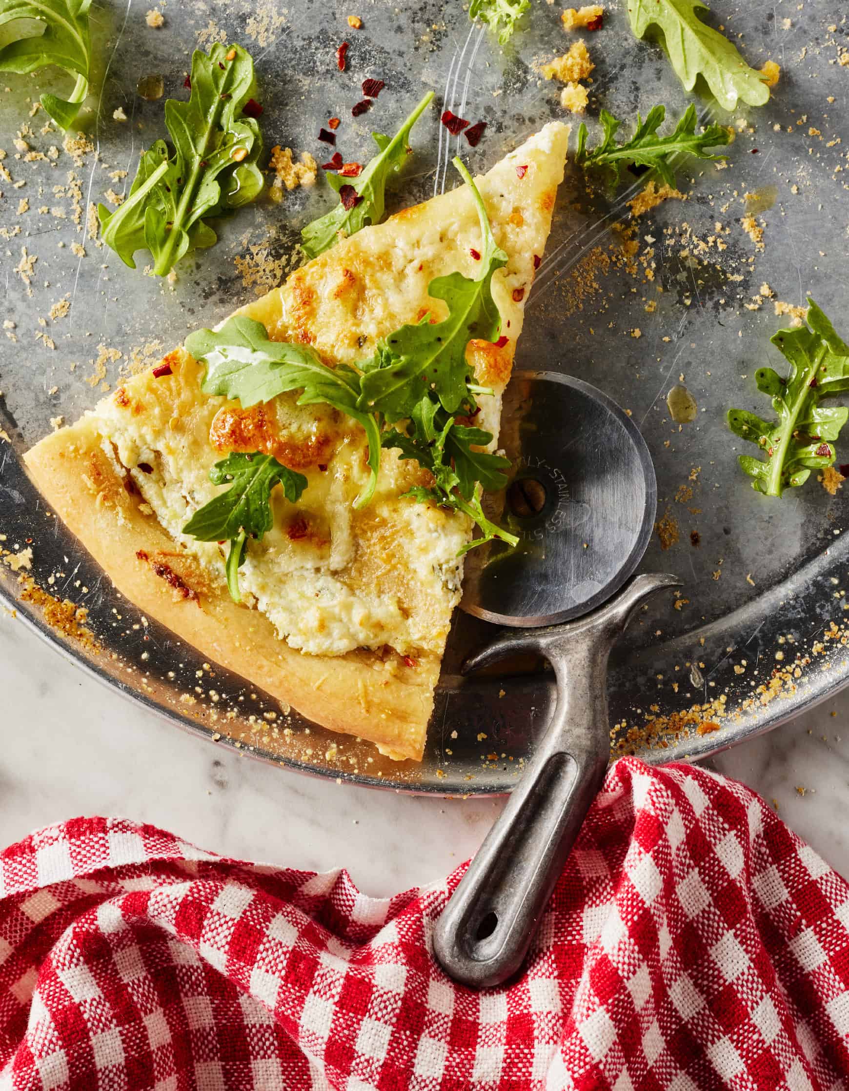 Slice of white pizza on pizza pan