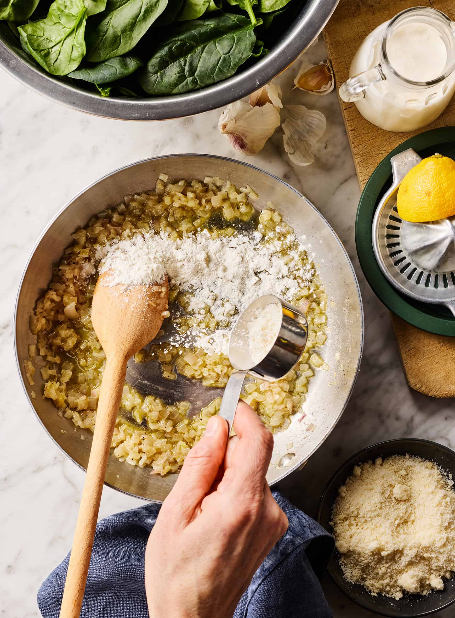 Adding flour to skillet with shallots and butter