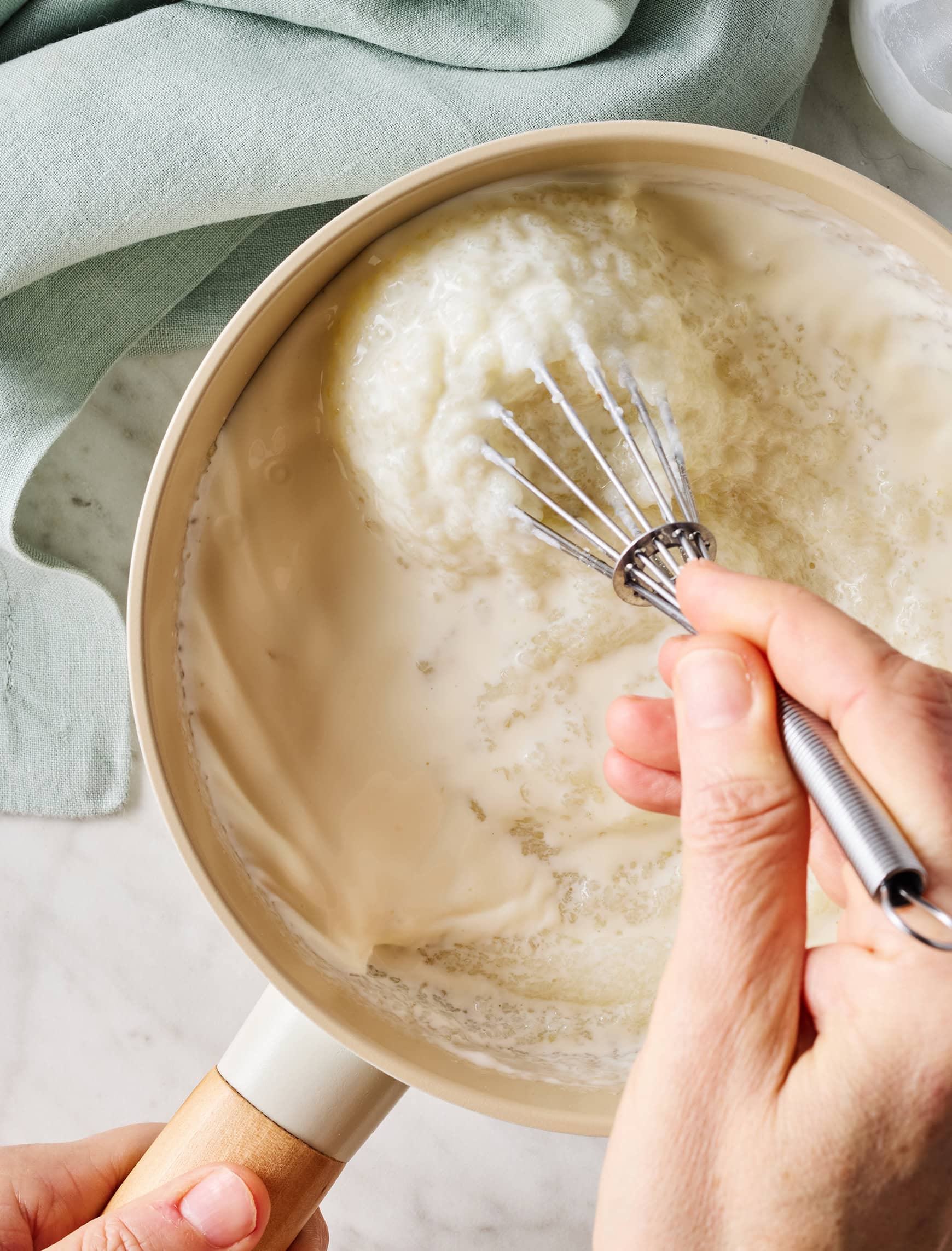 Cooking creamy grits in saucepan