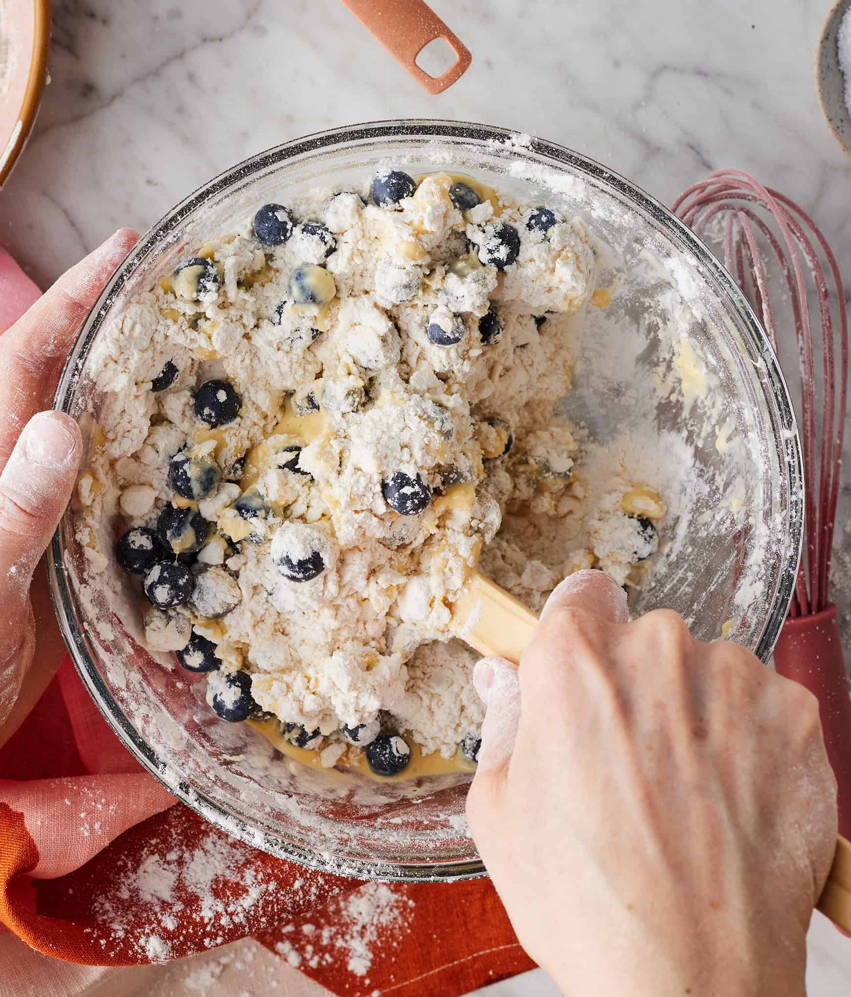Using spatula to combine wet and dry ingredients