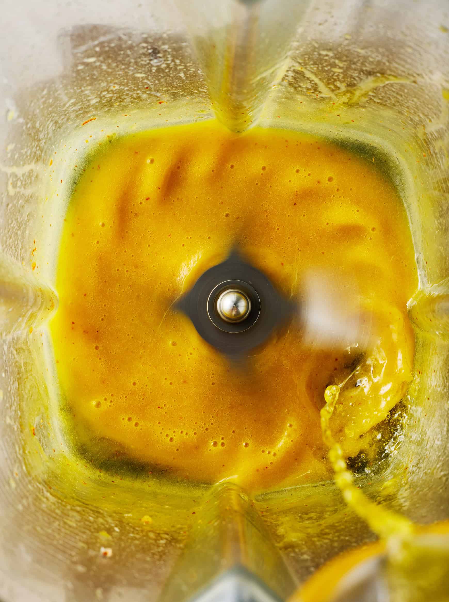 Drizzling melted butter into blender with egg mixture
