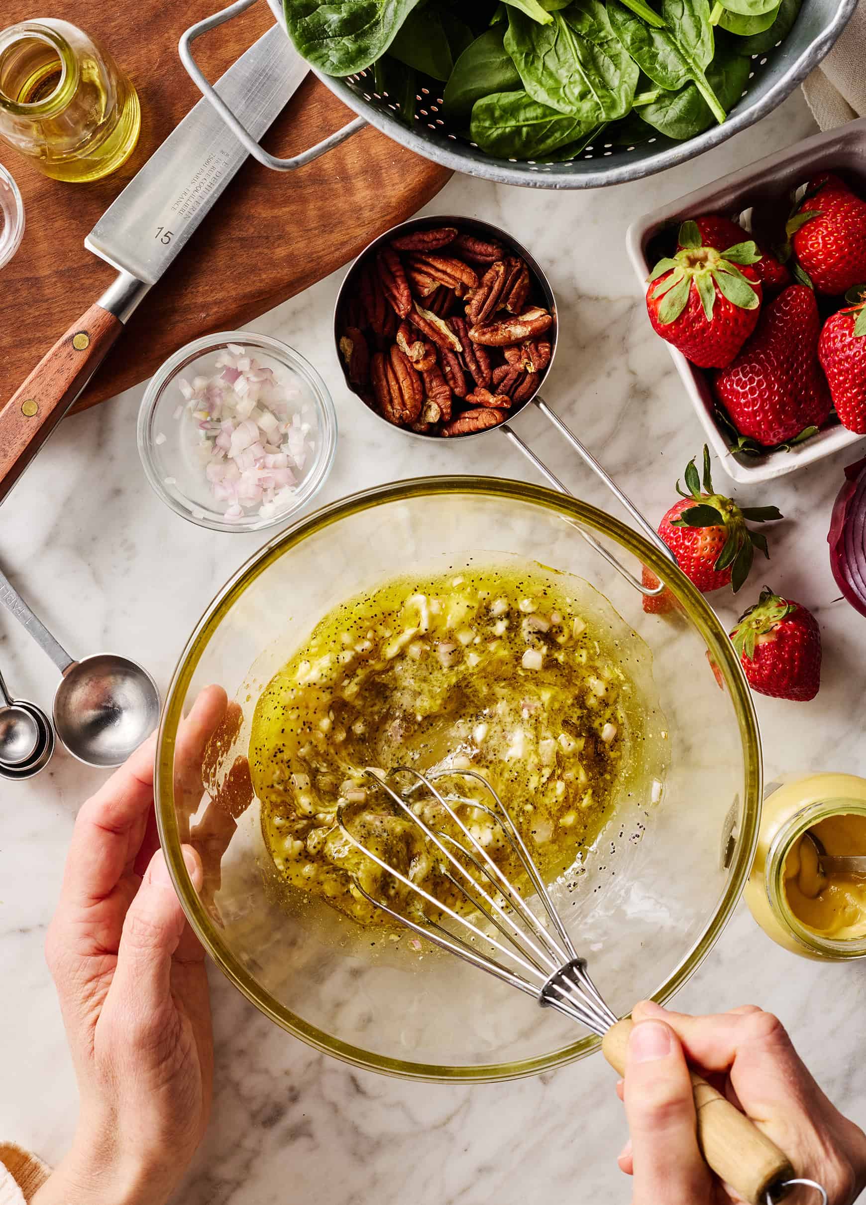 Whisking dressing ingredients in glass bowl