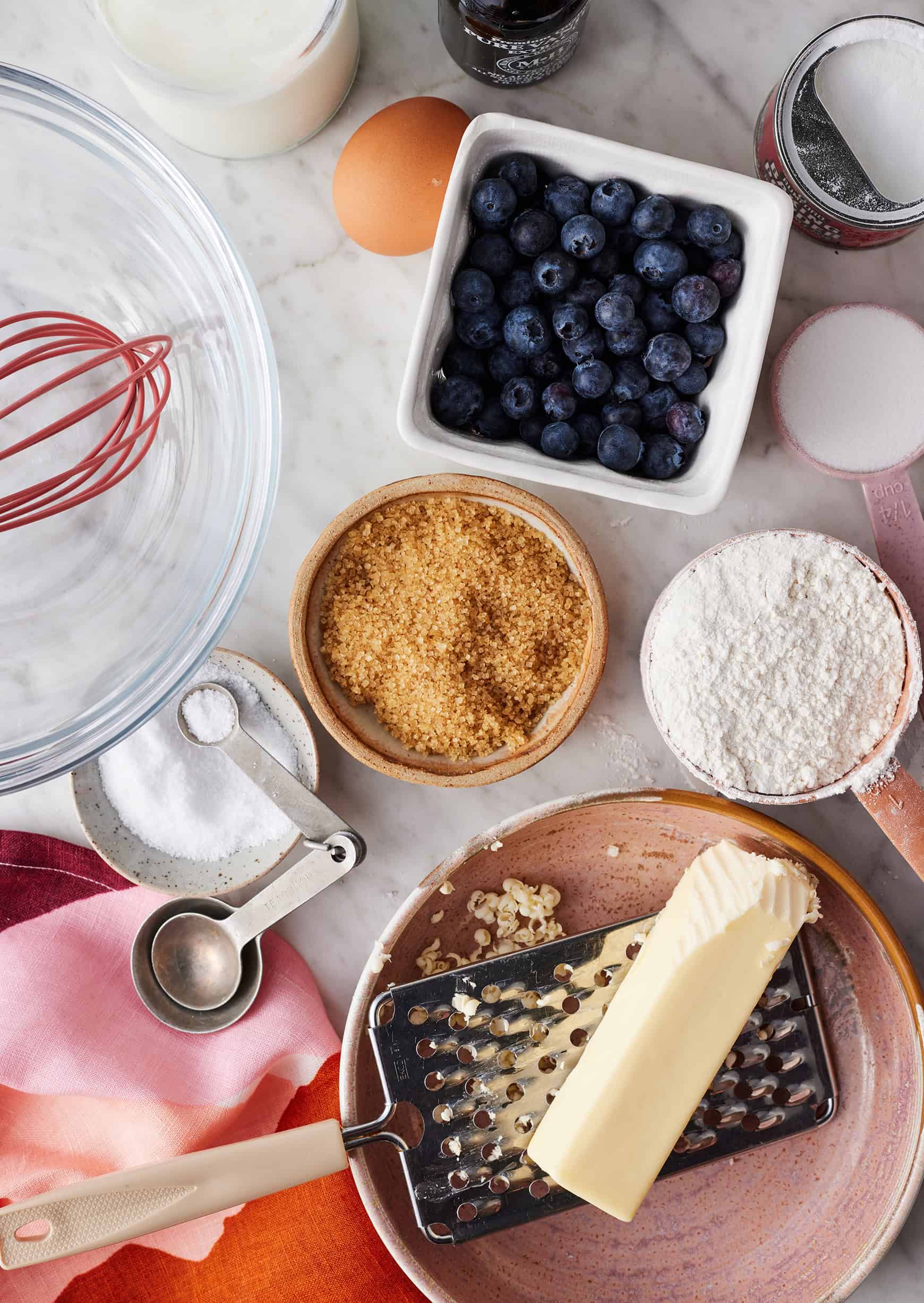 Scone recipe ingredients - frozen grated butter, flour, sugar, salt, egg, buttermilk, baking powder, and add-ins