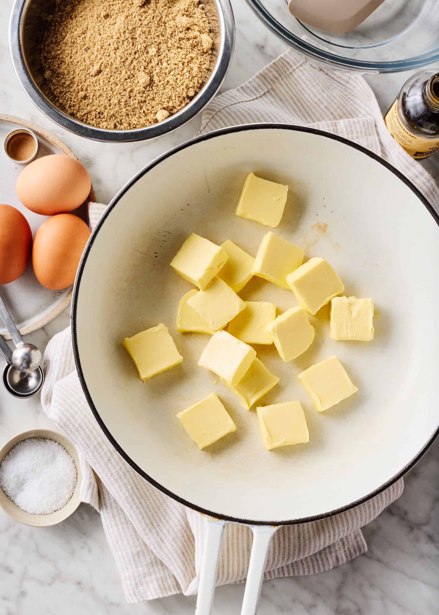 Pats of butter in light skillet