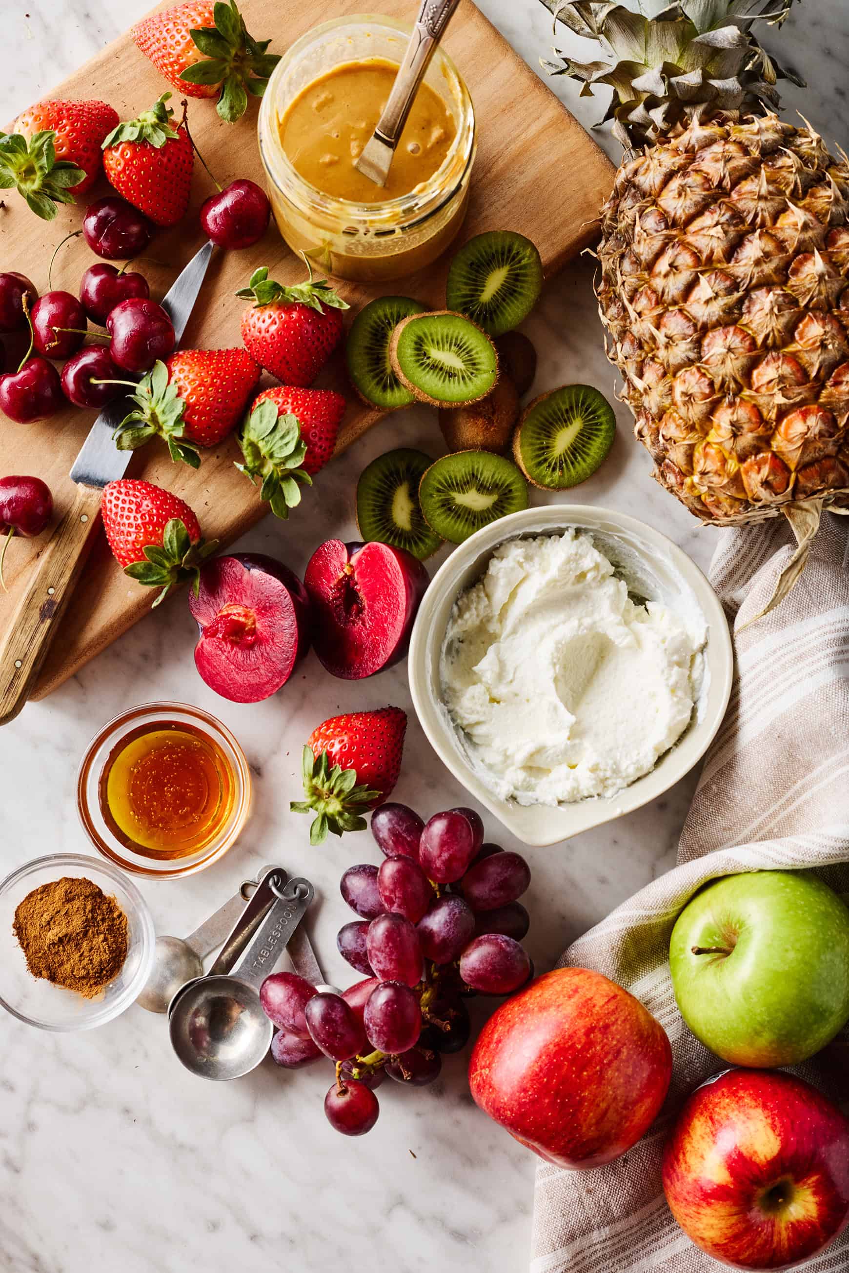 Dip ingredients (peanut butter, whole milk Greek yogurt, honey, and cinnamon) with fresh fruit