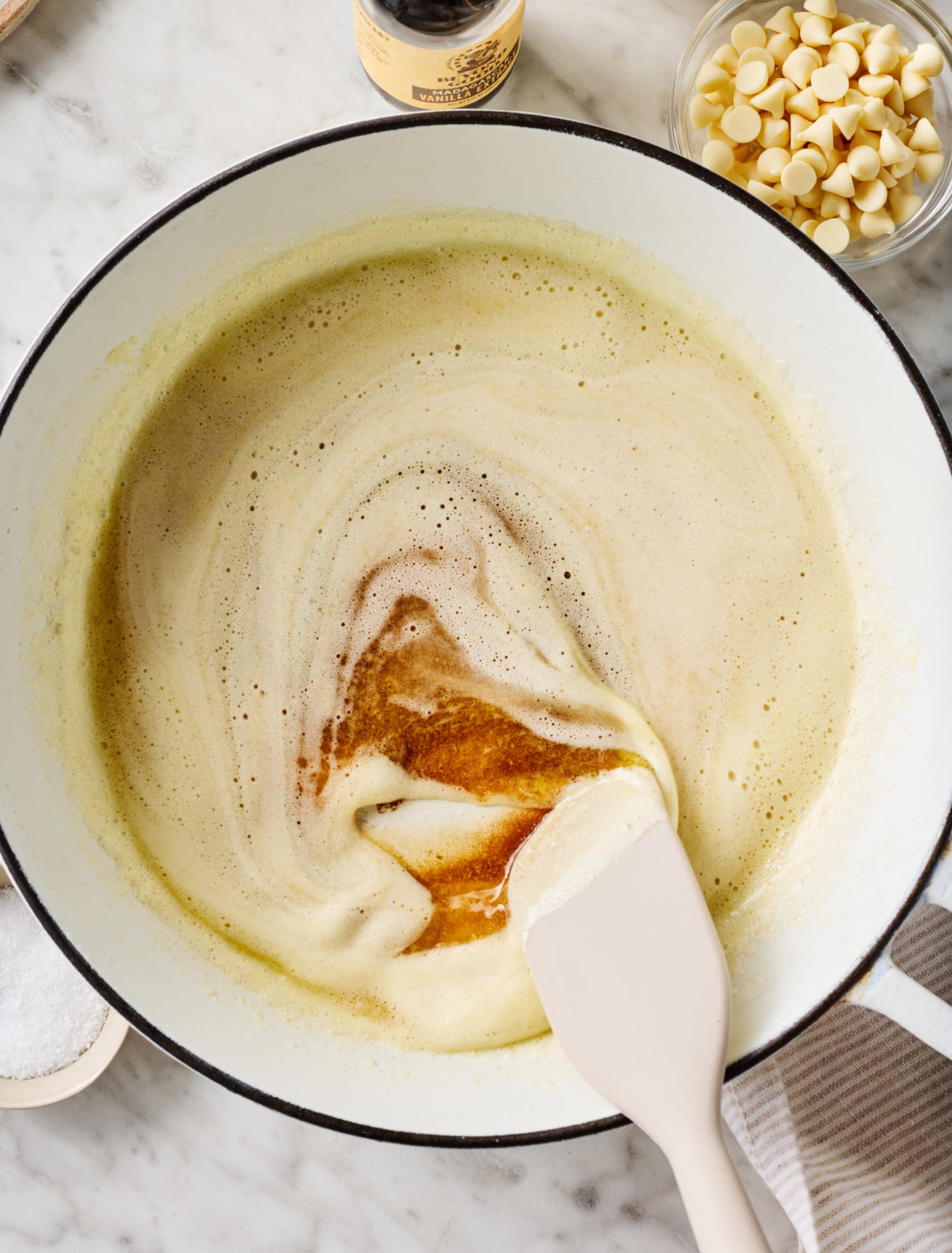 Stirring foamy butter in white skillet