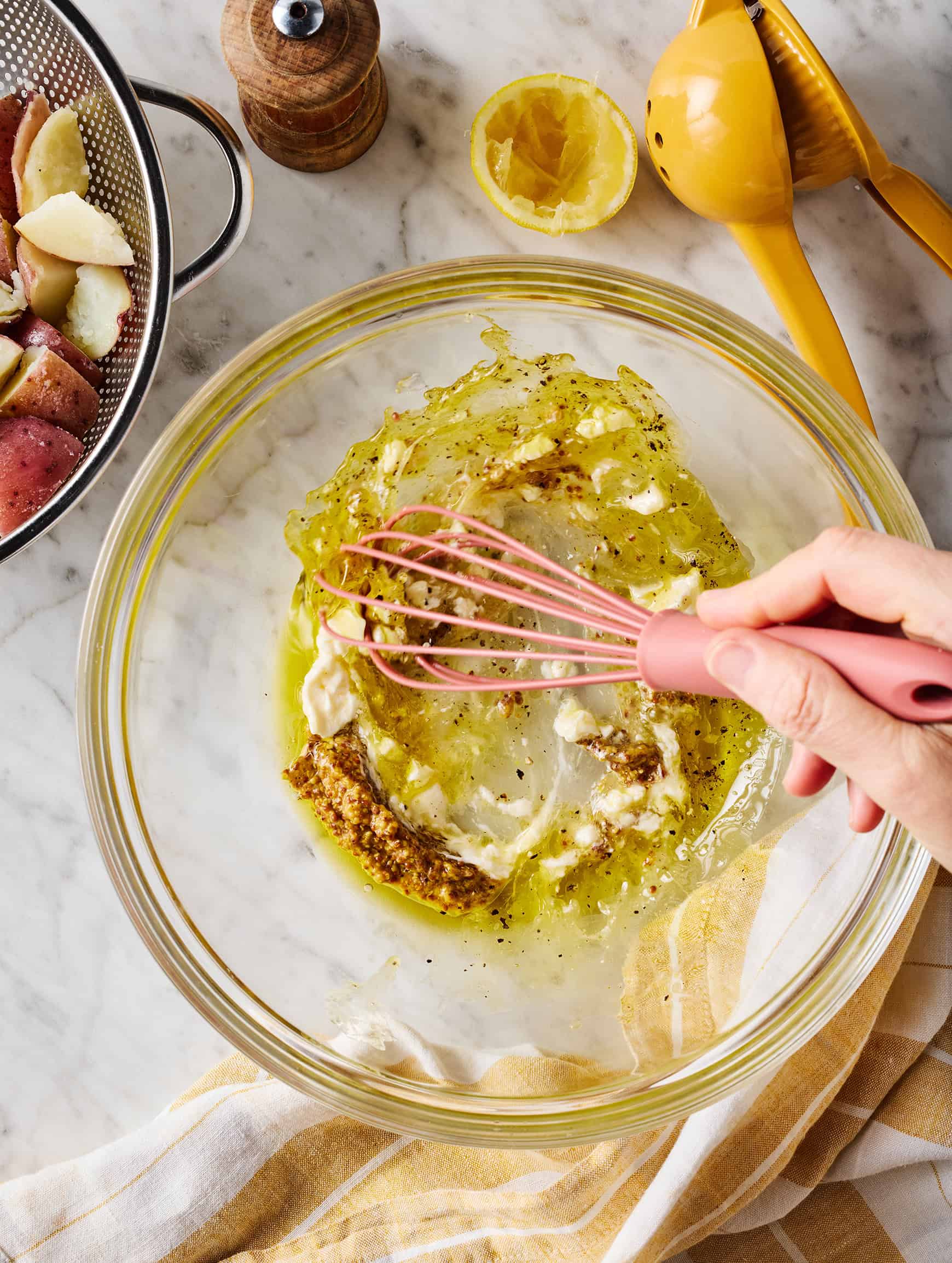 Whisking dressing in glass bowl