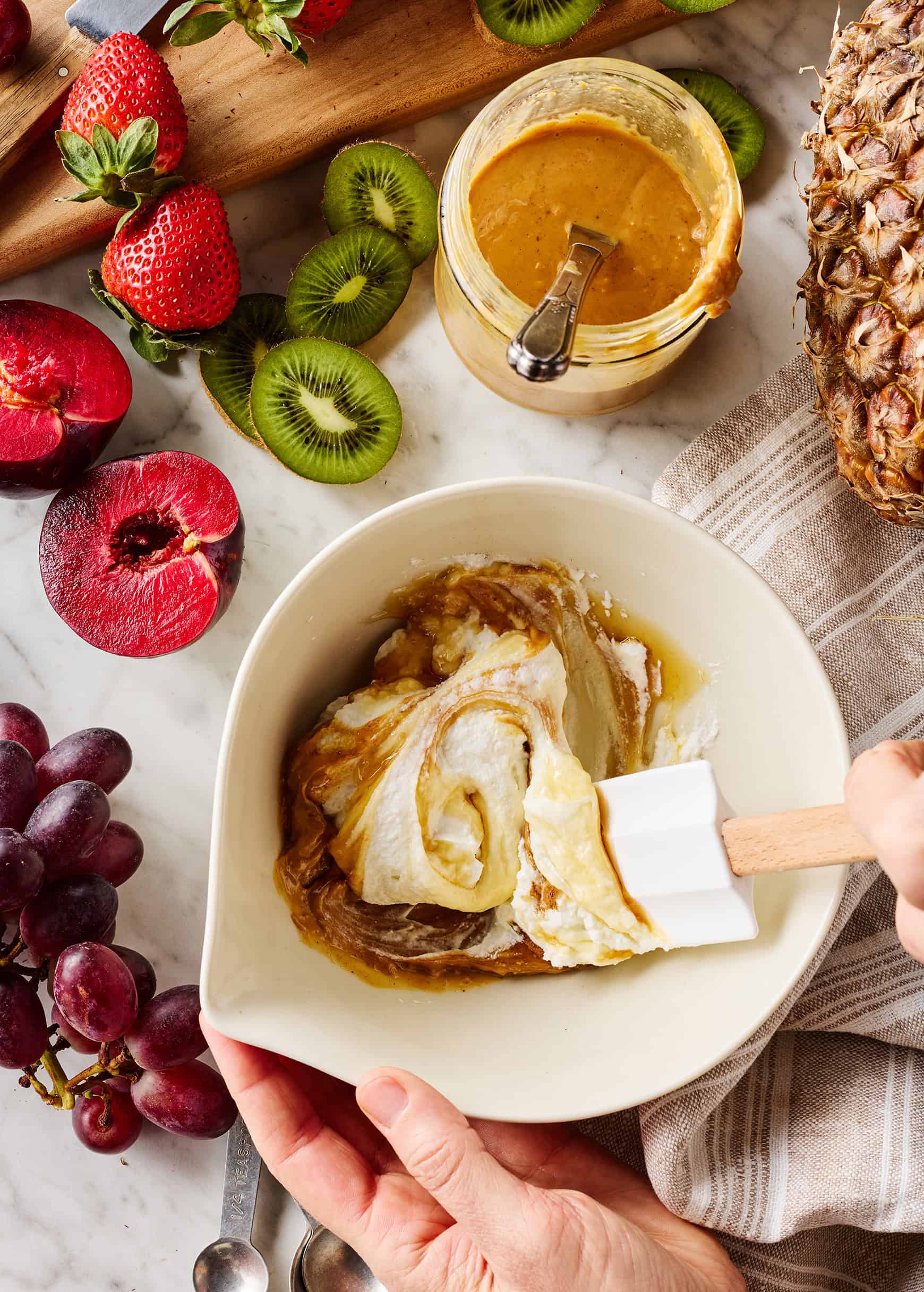 Stirring together fruit dip ingredients in bowl