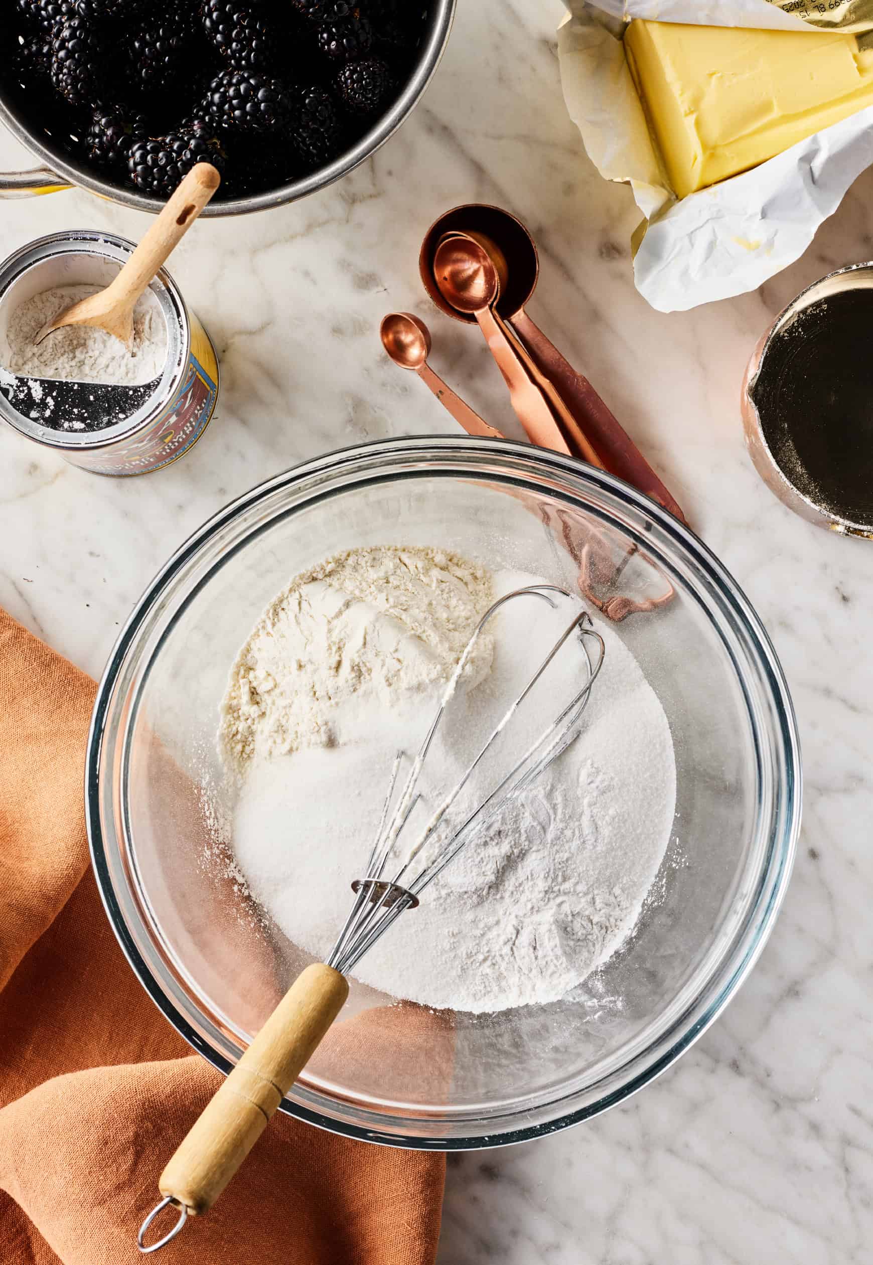 Dry ingredients in a glass bowl with whisk
