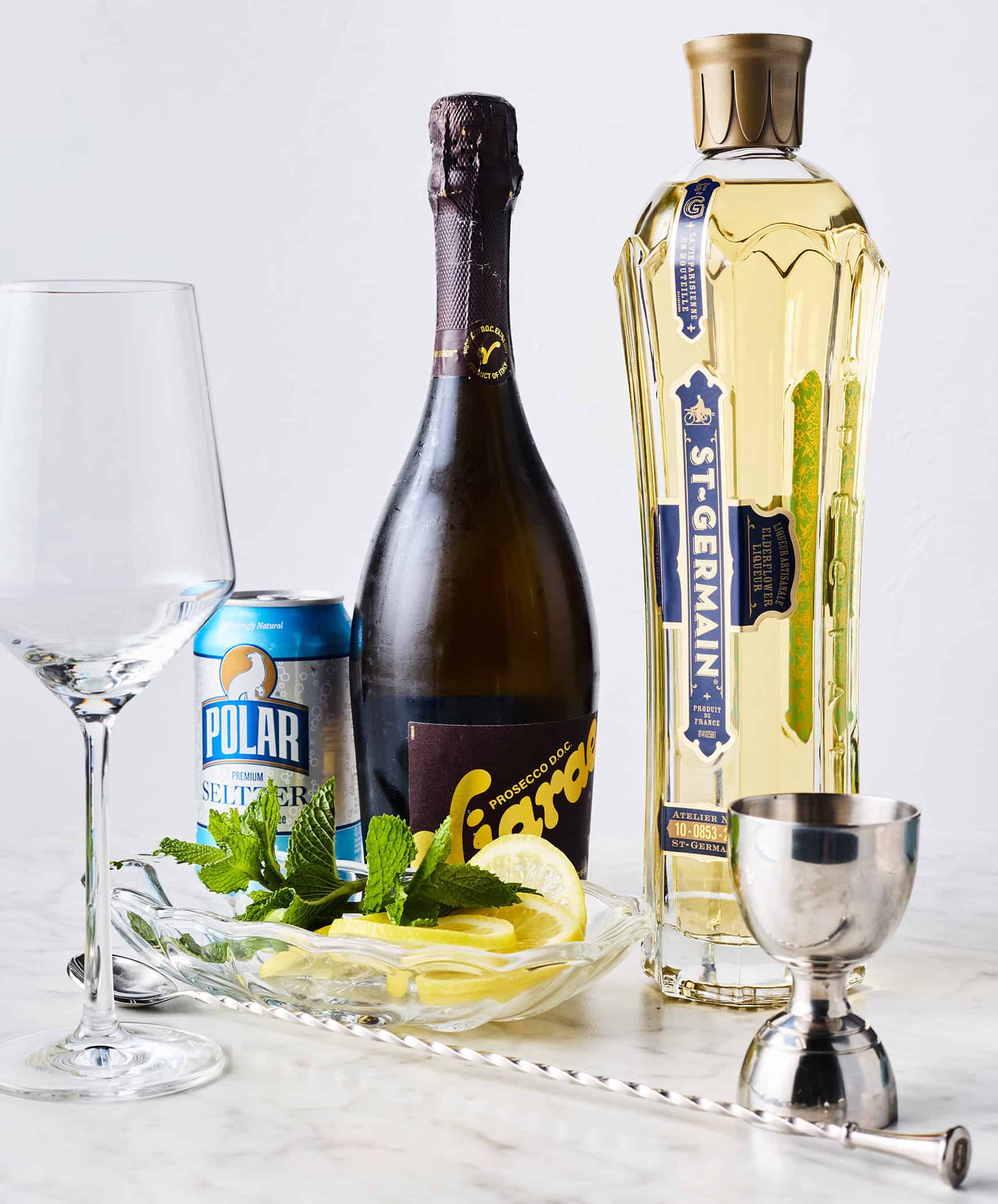 St. Germain (elderflower liqueur), prosecco, sparkling water, lemon slices, and fresh mint