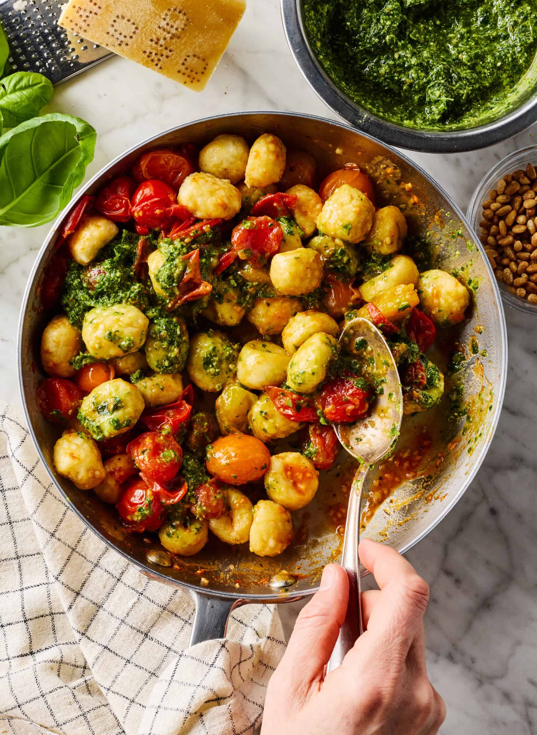 Gently stirring sauce into tomato and gnocchi mixture in skillet