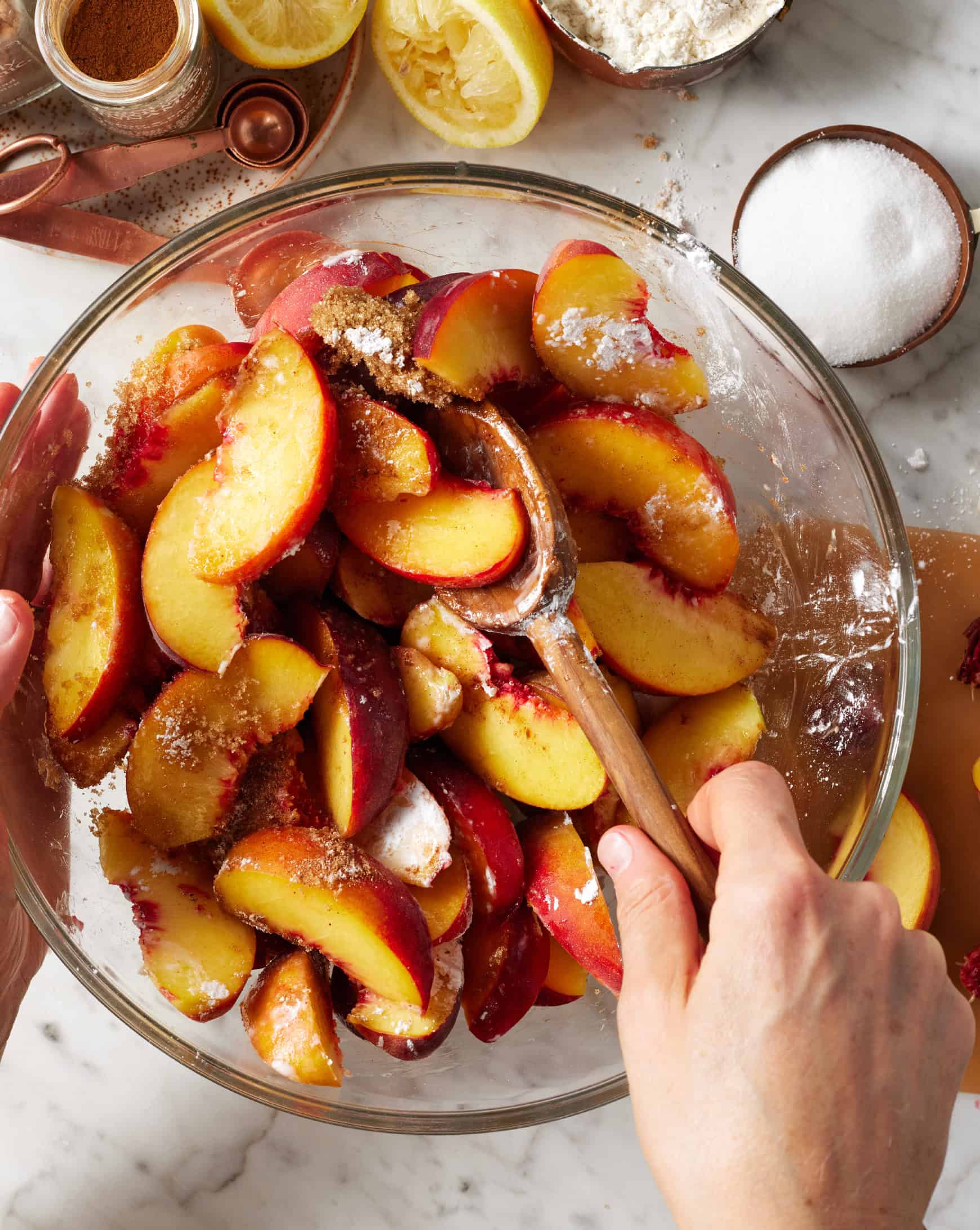 Mixing sliced peaches with cornstarch and spices