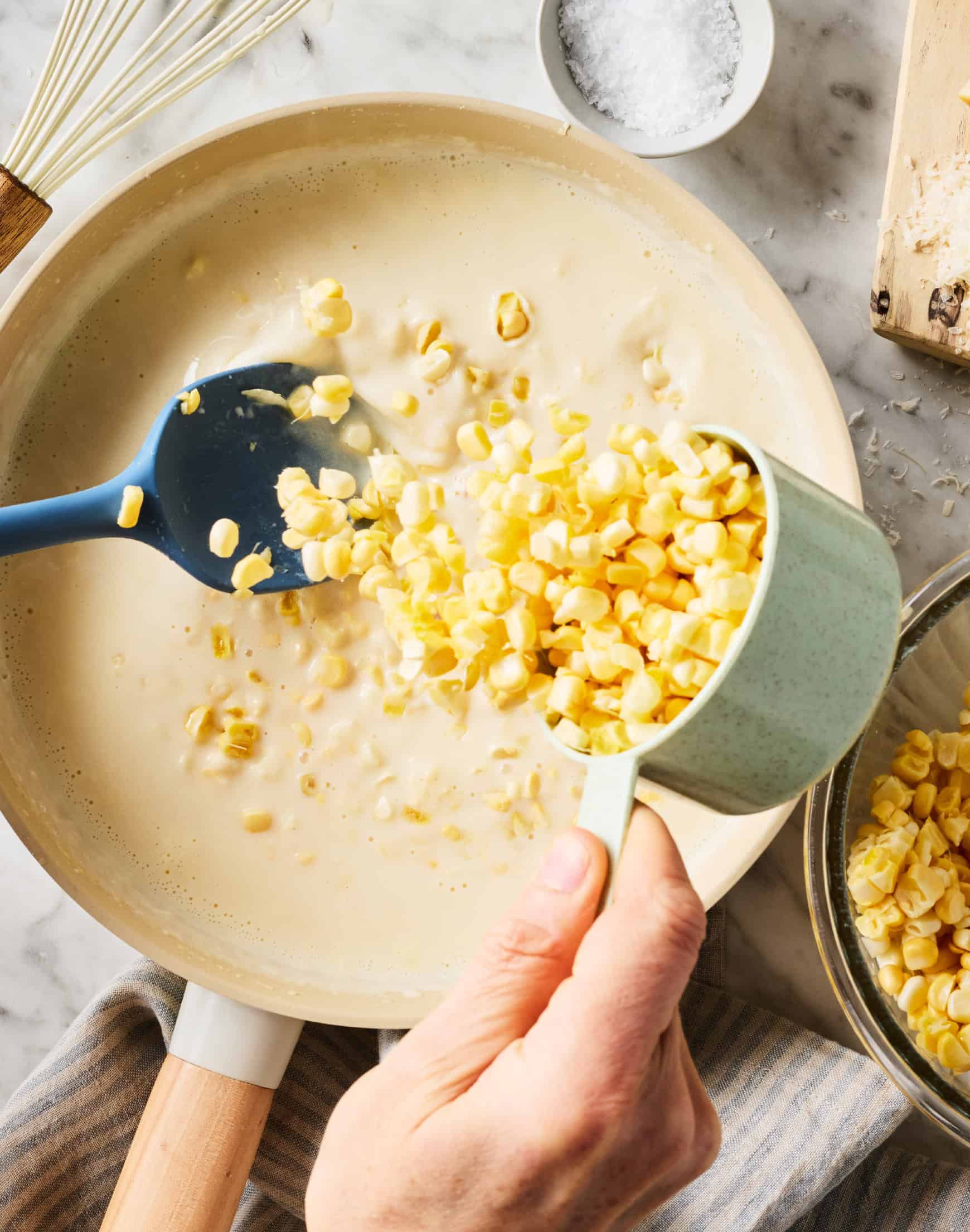 Adding fresh kernels to skillet with cream sauce