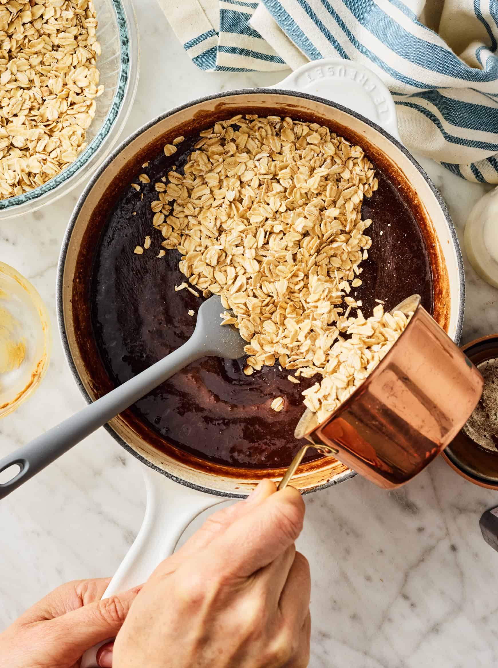 Adding oats to chocolate mixture in saucepan