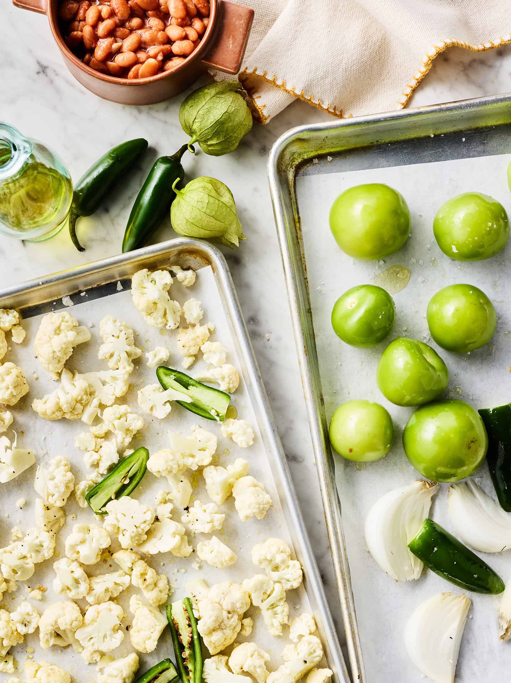 Vegetables for enchilada sauce and filling on baking sheets