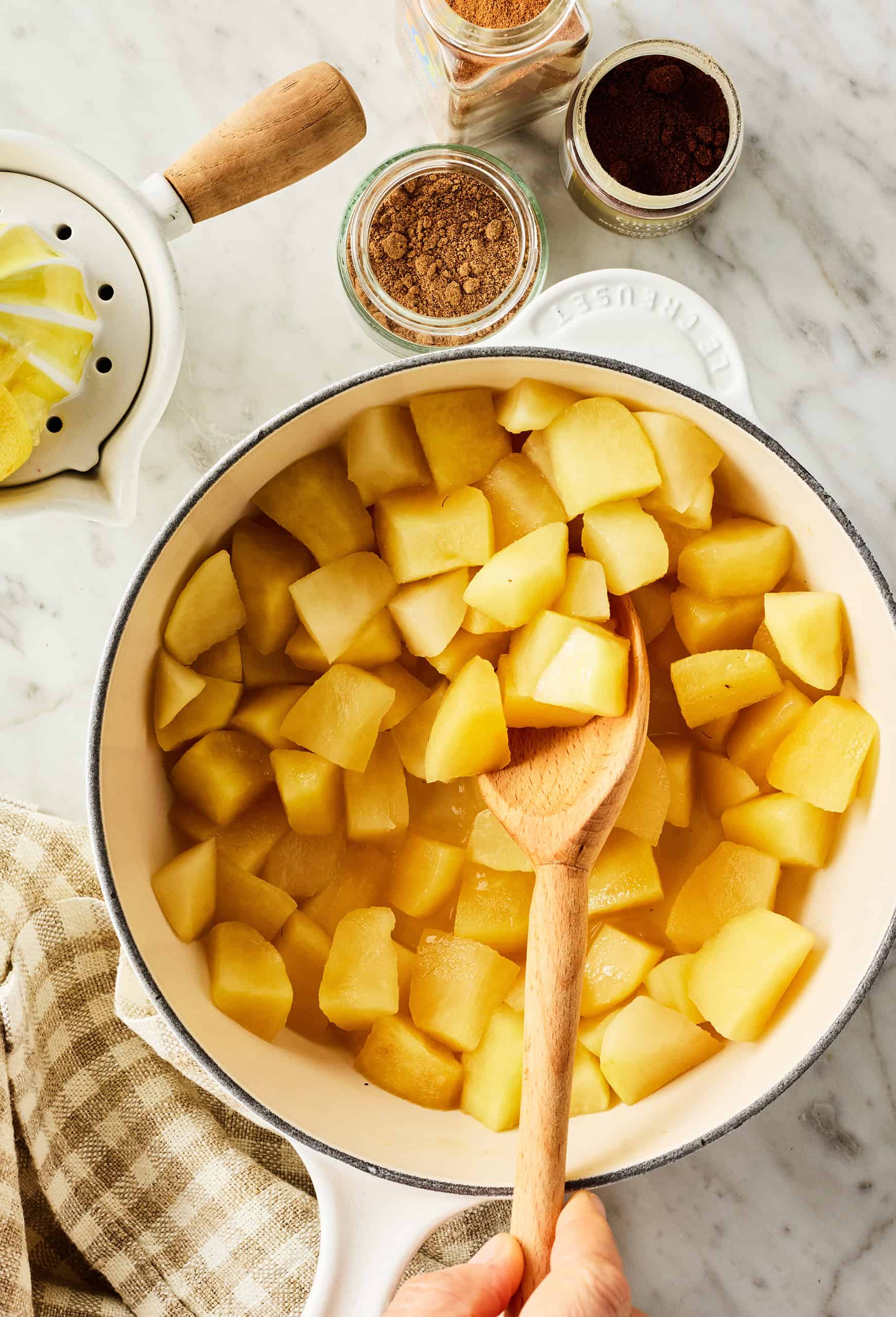 Simmering chopped apples in saucepan