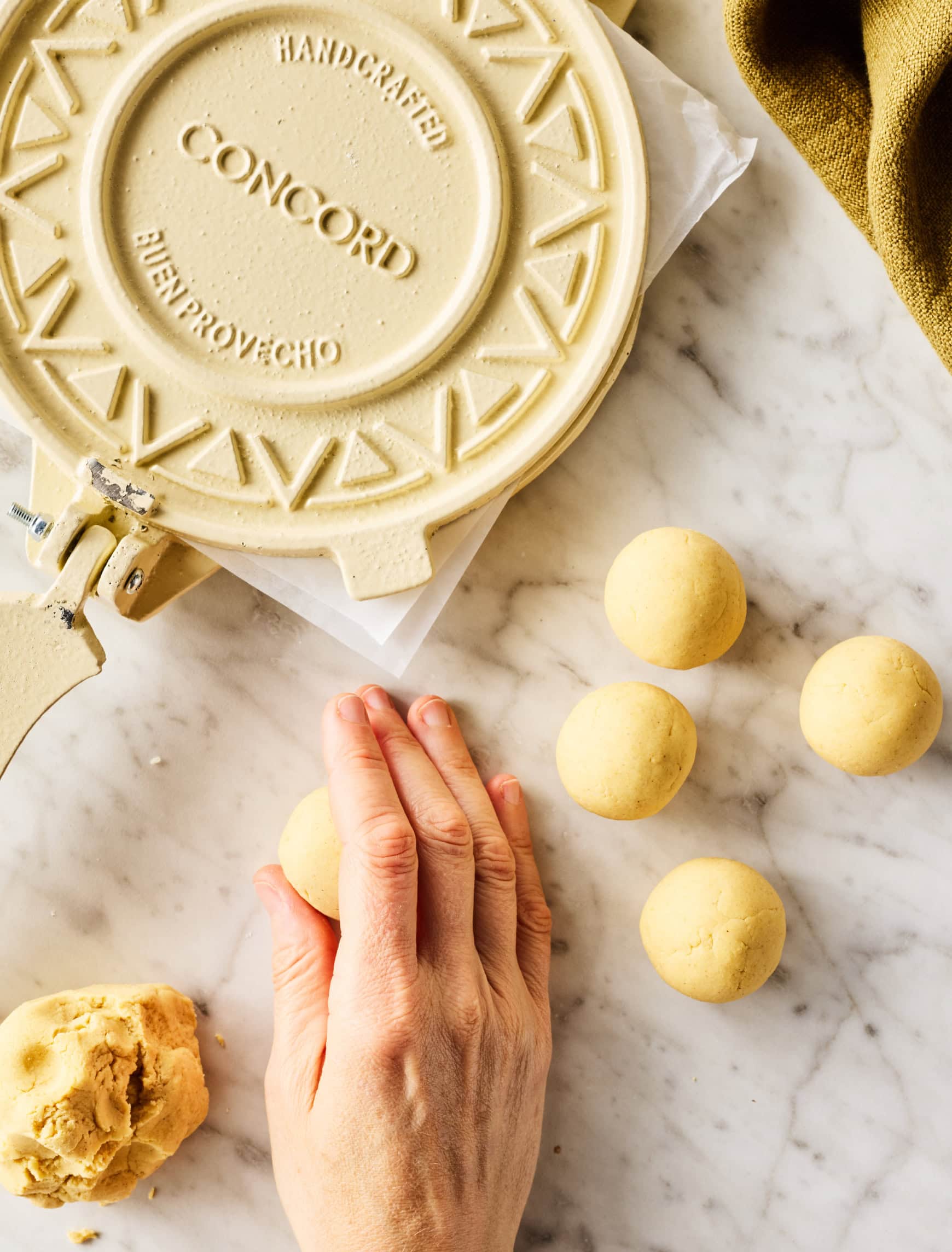 Rolling balls of masa dough with cupped hand