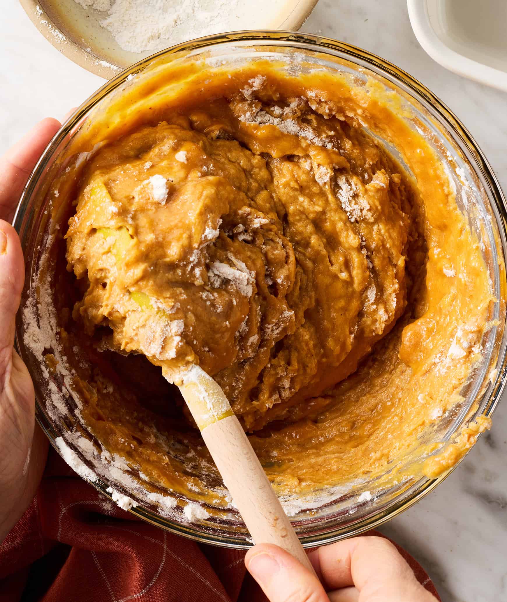 Mixing wet and dry ingredients together with wooden spoon