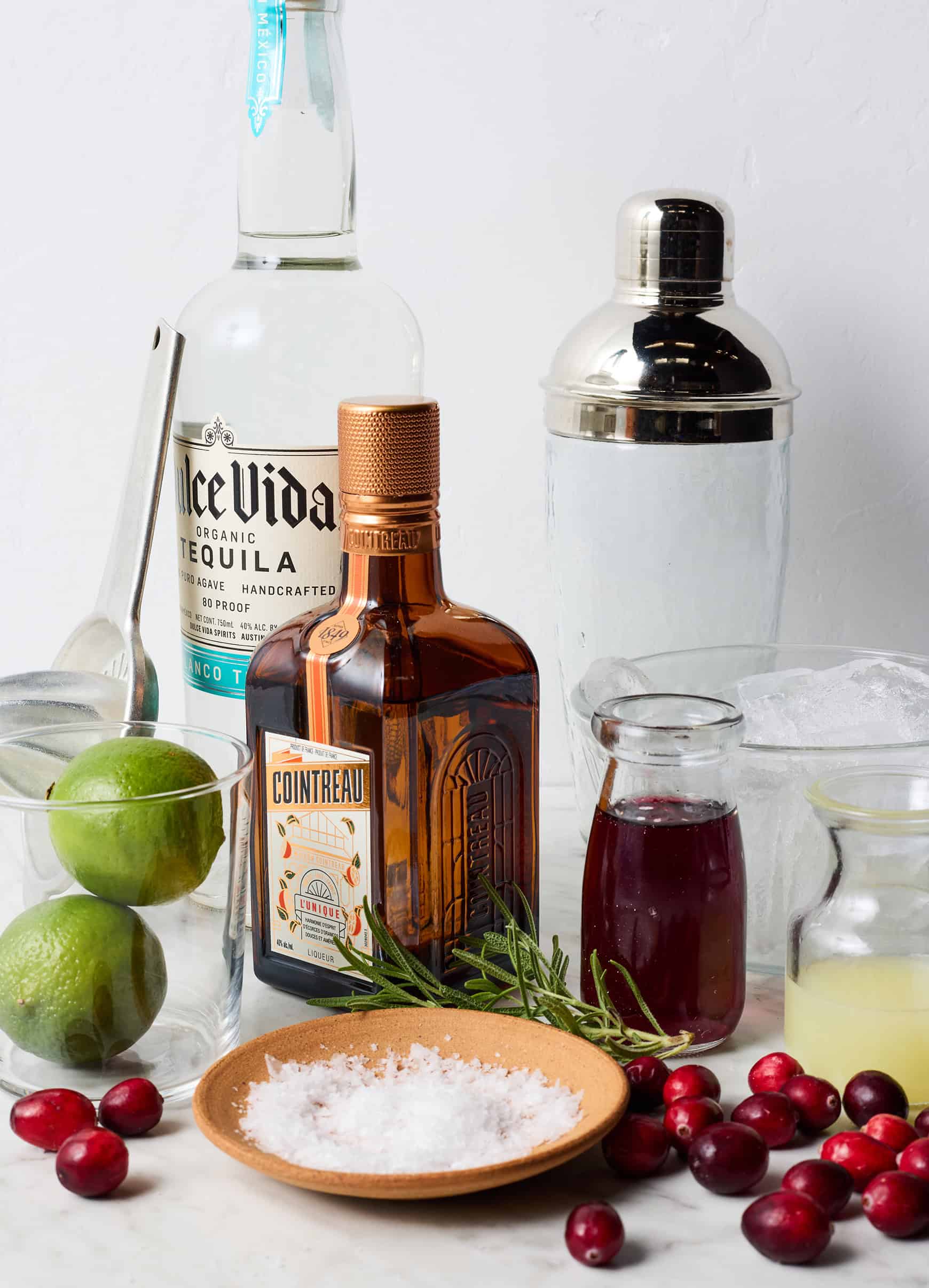 Recipe ingredients - cranberry juice, lime juice, Cointreau, tequila, fresh cranberries, salt, and ice