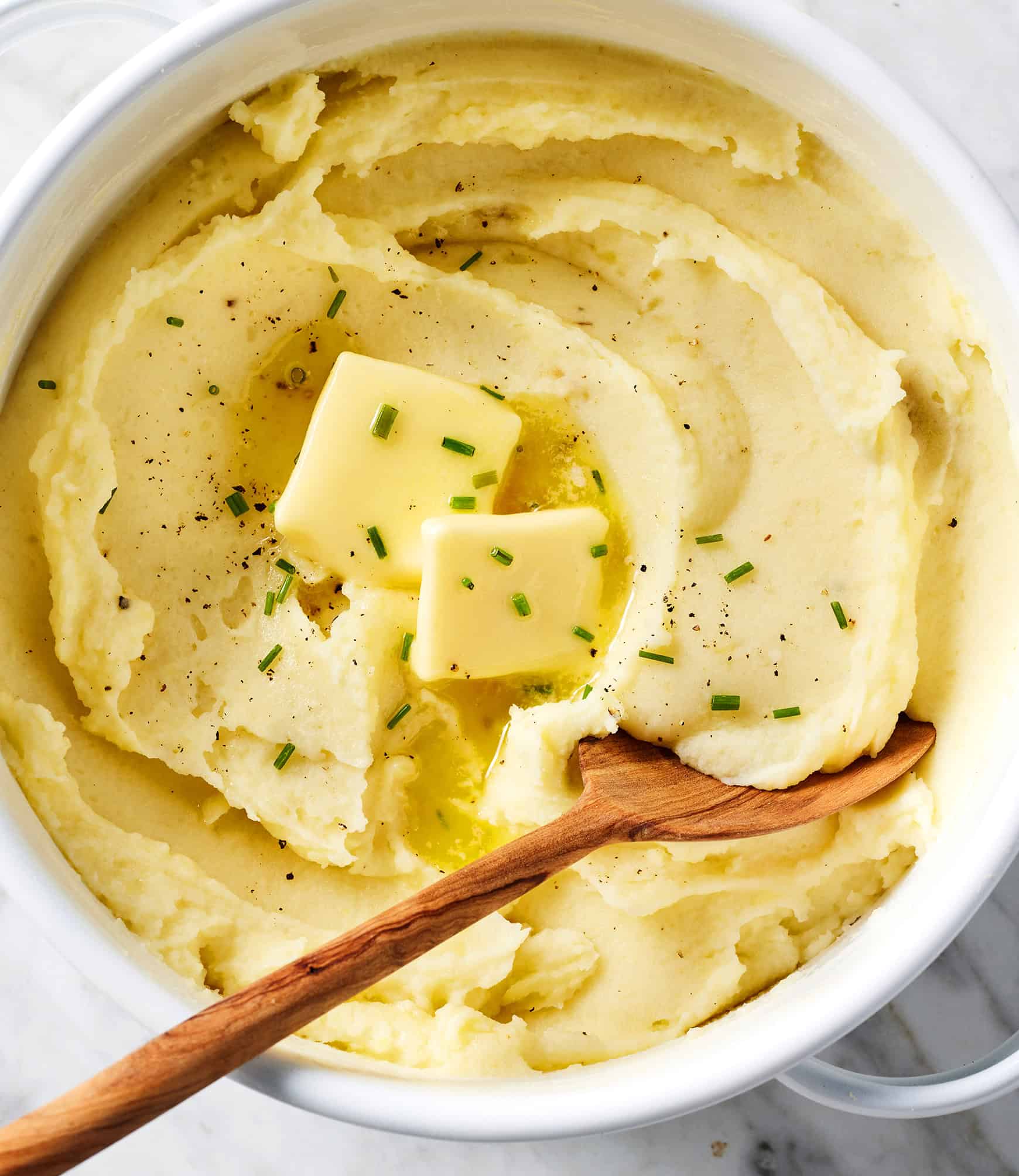 mashed potatoes in a pot with a serving spoon