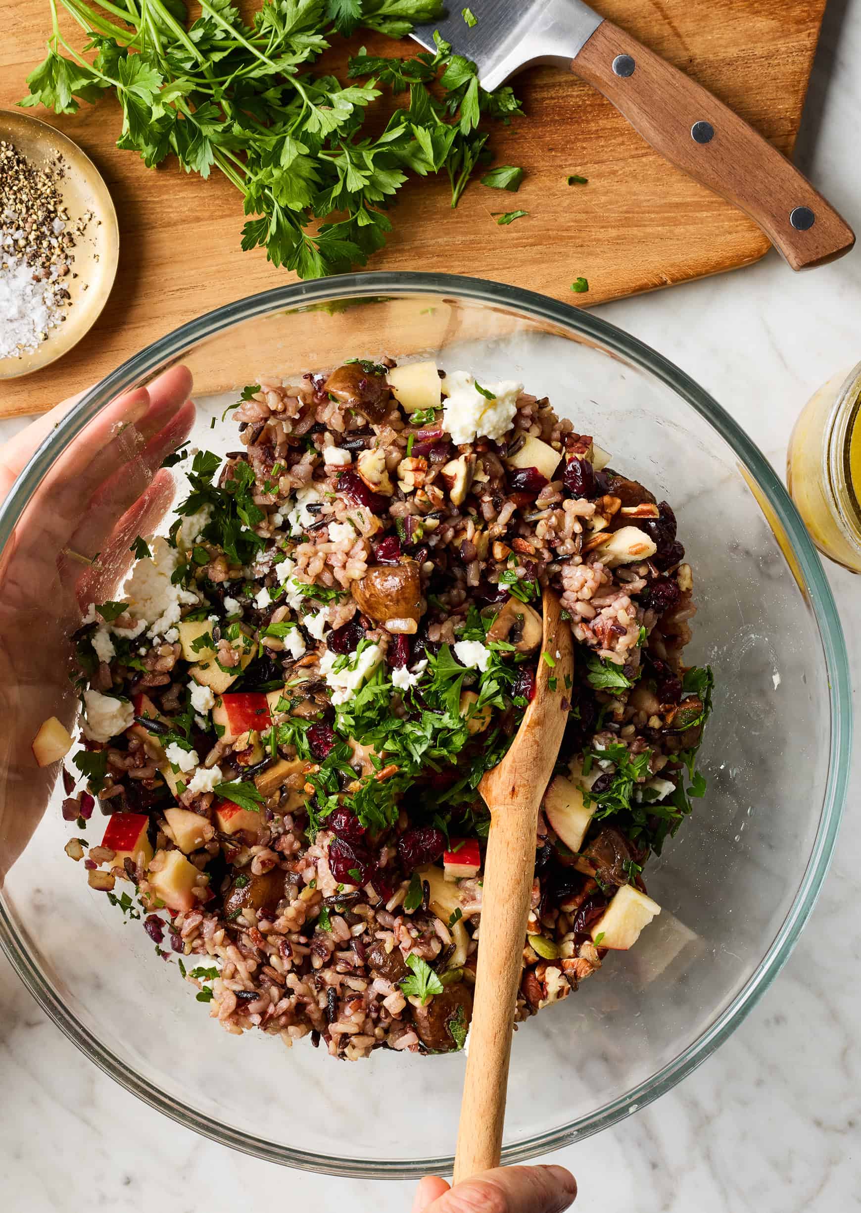 Mixing filling ingredients in bowl with wooden spoon