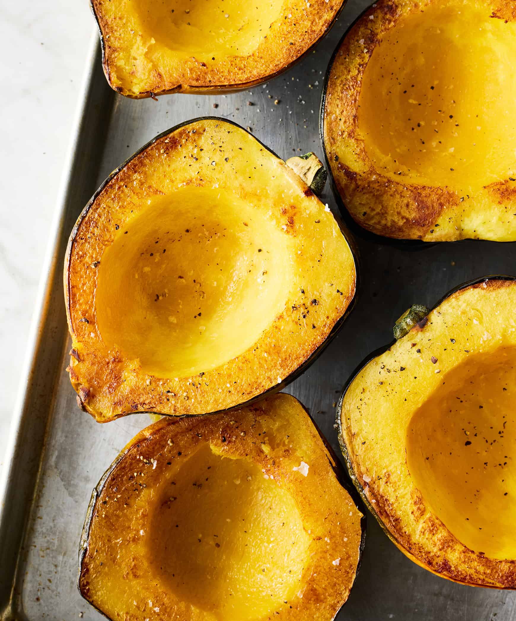 Roasted acorn squash on baking sheet