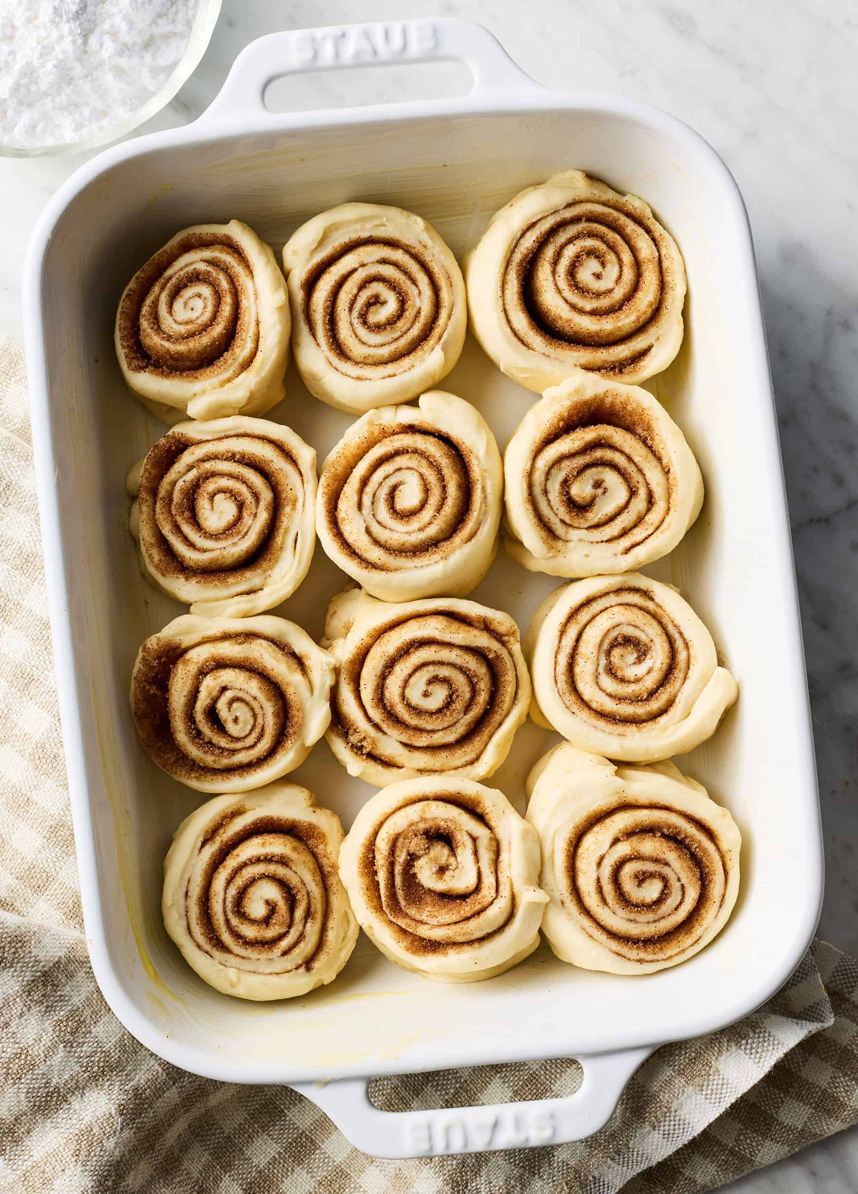 Unbaked cinnamon rolls in baking dish