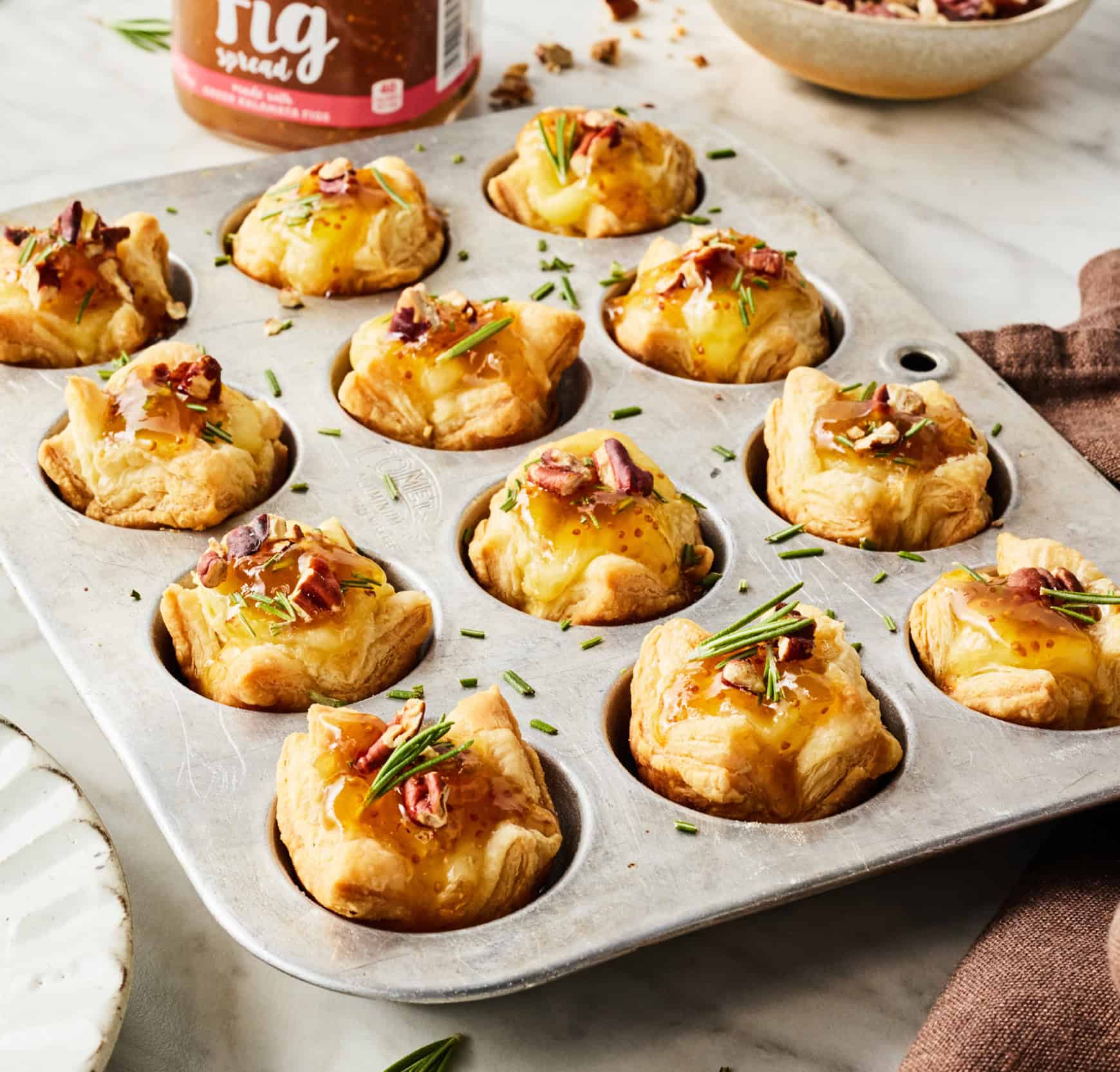 Christmas appetizers - puff pastry brie bites in muffin tin